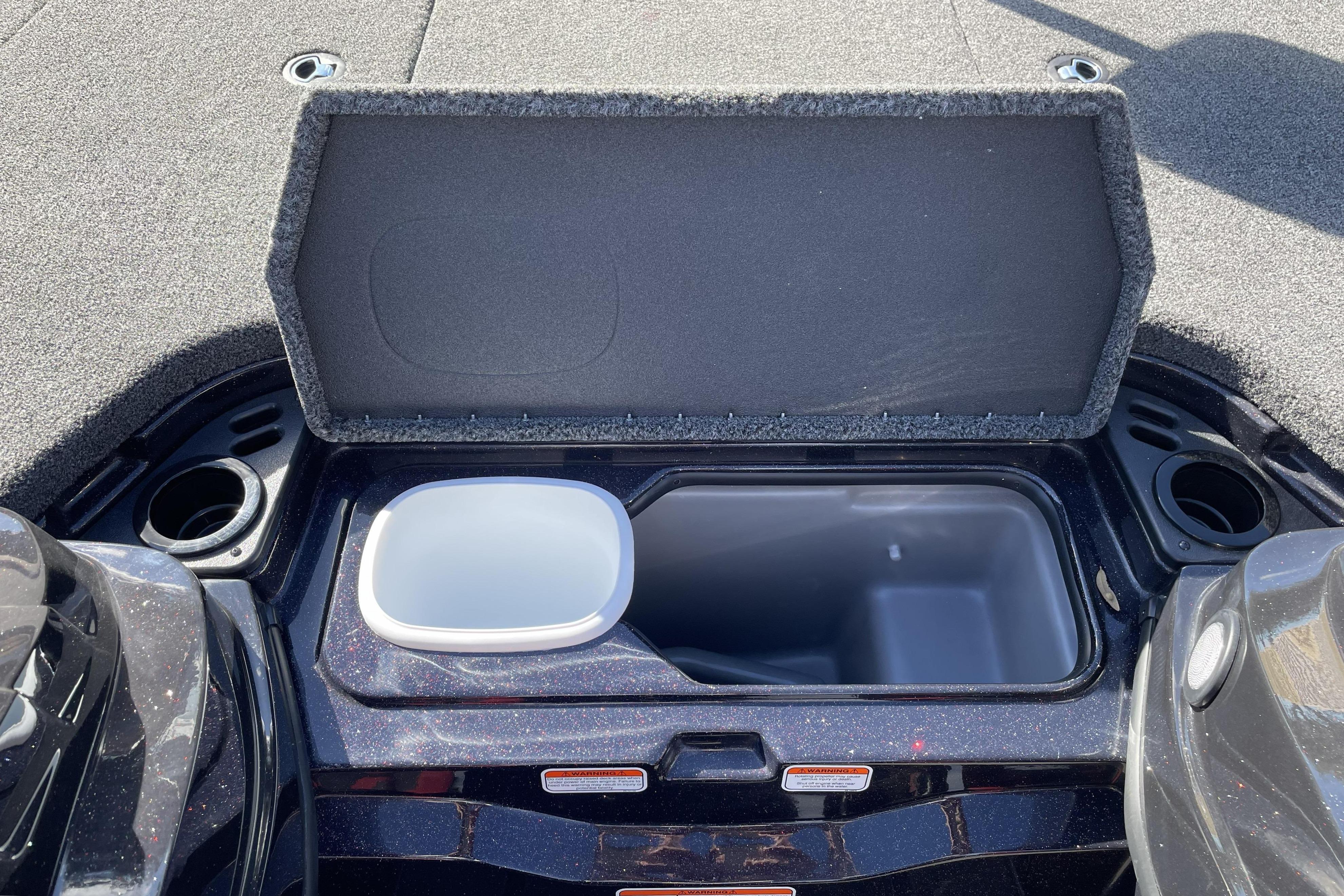 Open storage compartment on 2026 Nitro Z19 XL boat, featuring cup holders and carpeted lid.