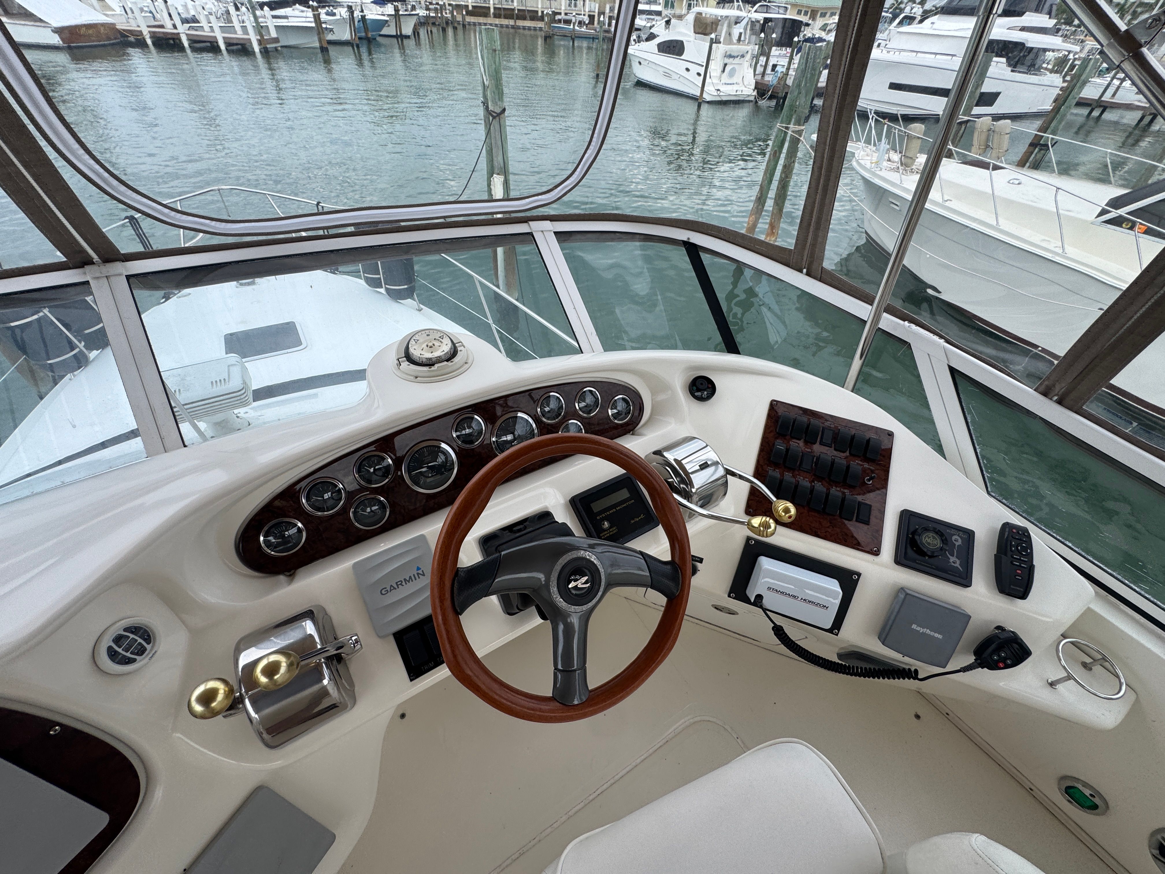 Helm of 2001 Sea Ray 380 Aft Cabin yacht in marina.