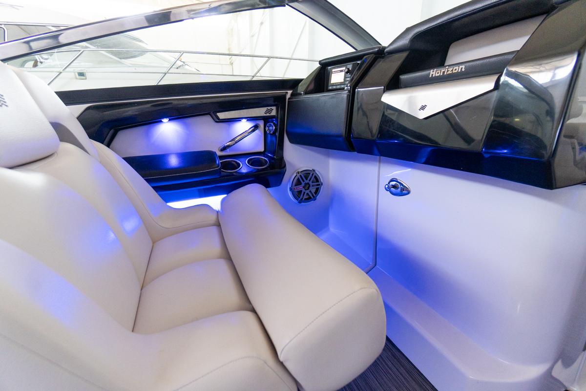 Interior of 2018 Four Winns 290 Horizon boat with blue LED lighting and plush seating.