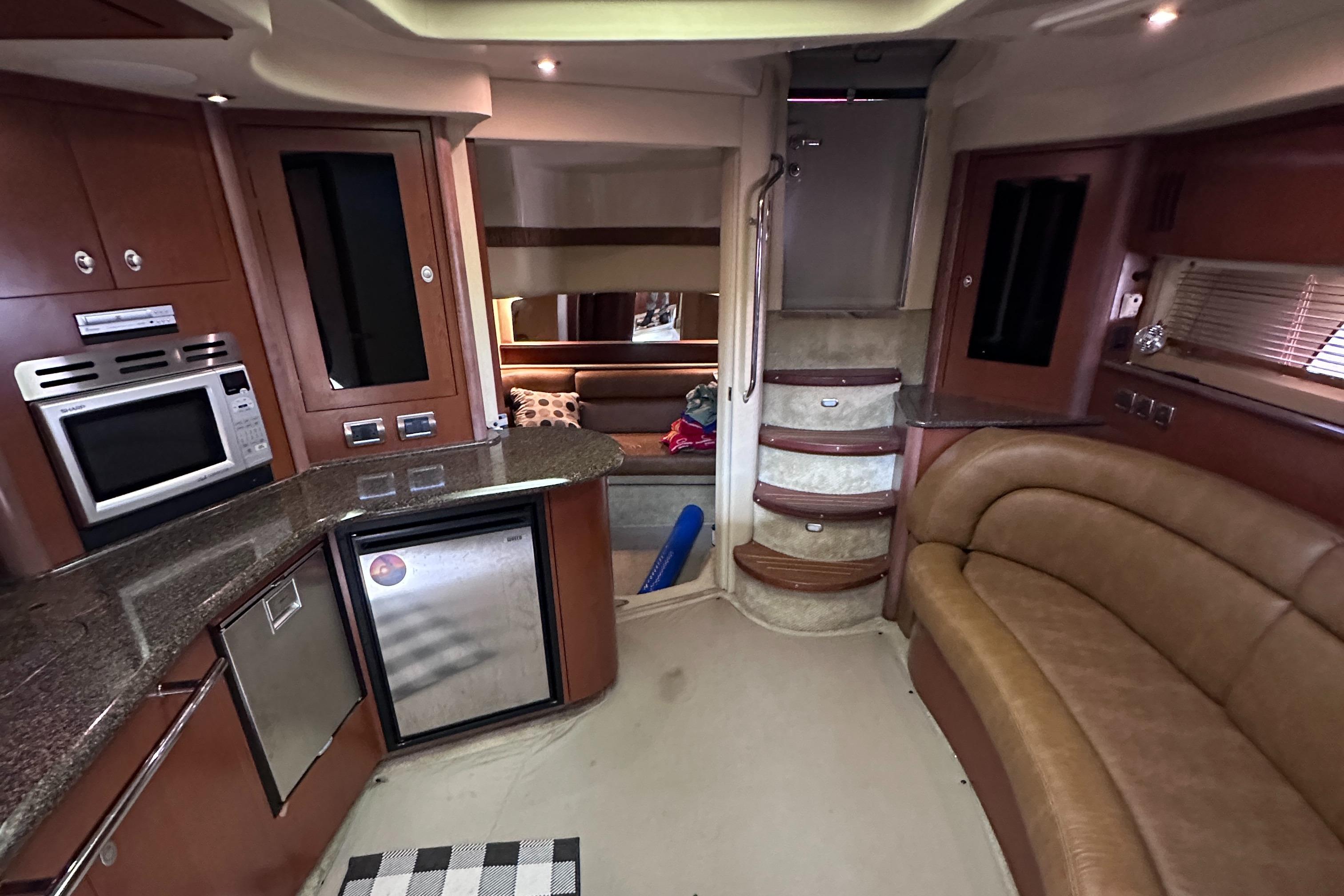 Interior of 2007 Sea Ray 44 Sundancer yacht with modern kitchen and seating area.