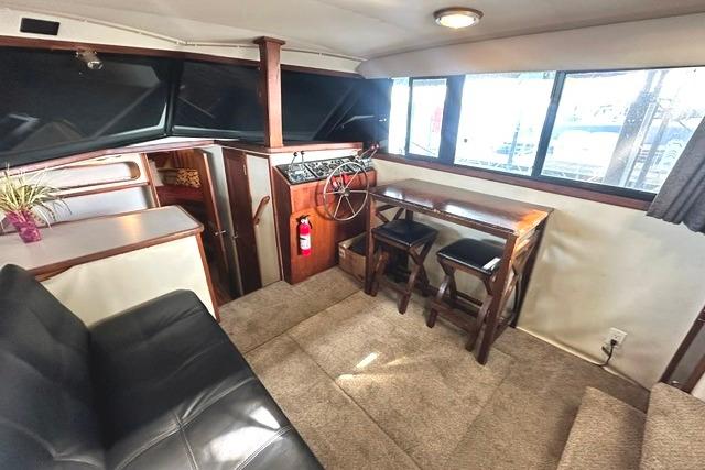 Interior of 1989 Carver 32 Aft Cabin Motor Yacht with seating and helm.