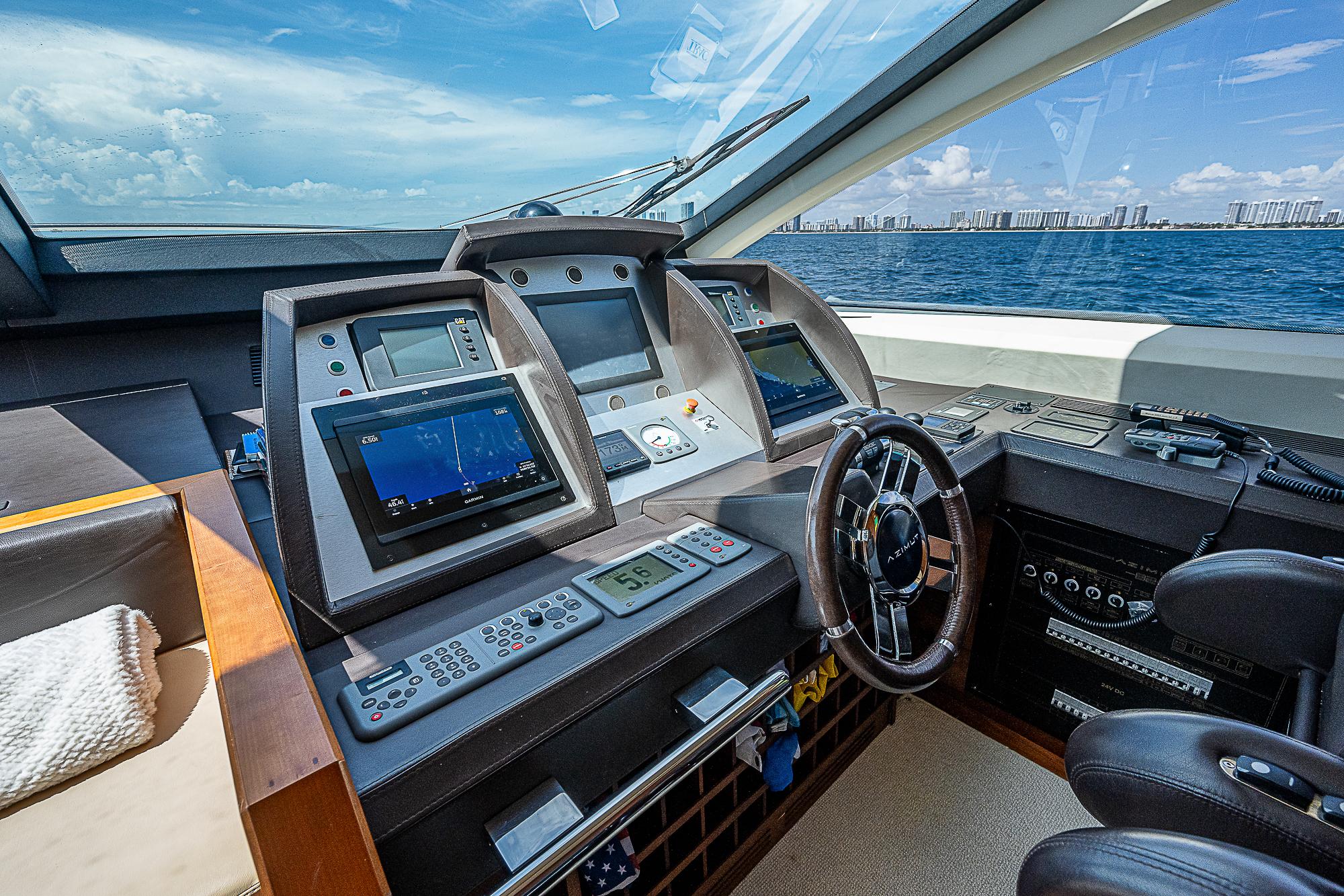 Luxurious 2011 Azimut 82 yacht cockpit with advanced navigation systems and ocean view.