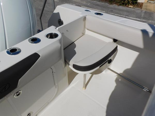 2024 Sailfish 242 CC boat interior with foldable seat and cup holders.