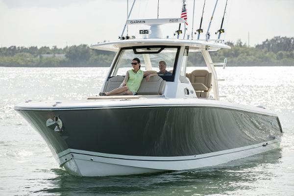 Manufacturer Provided Image: 2018 Pursuit S 368 Sport boat cruising on water with two people onboard.