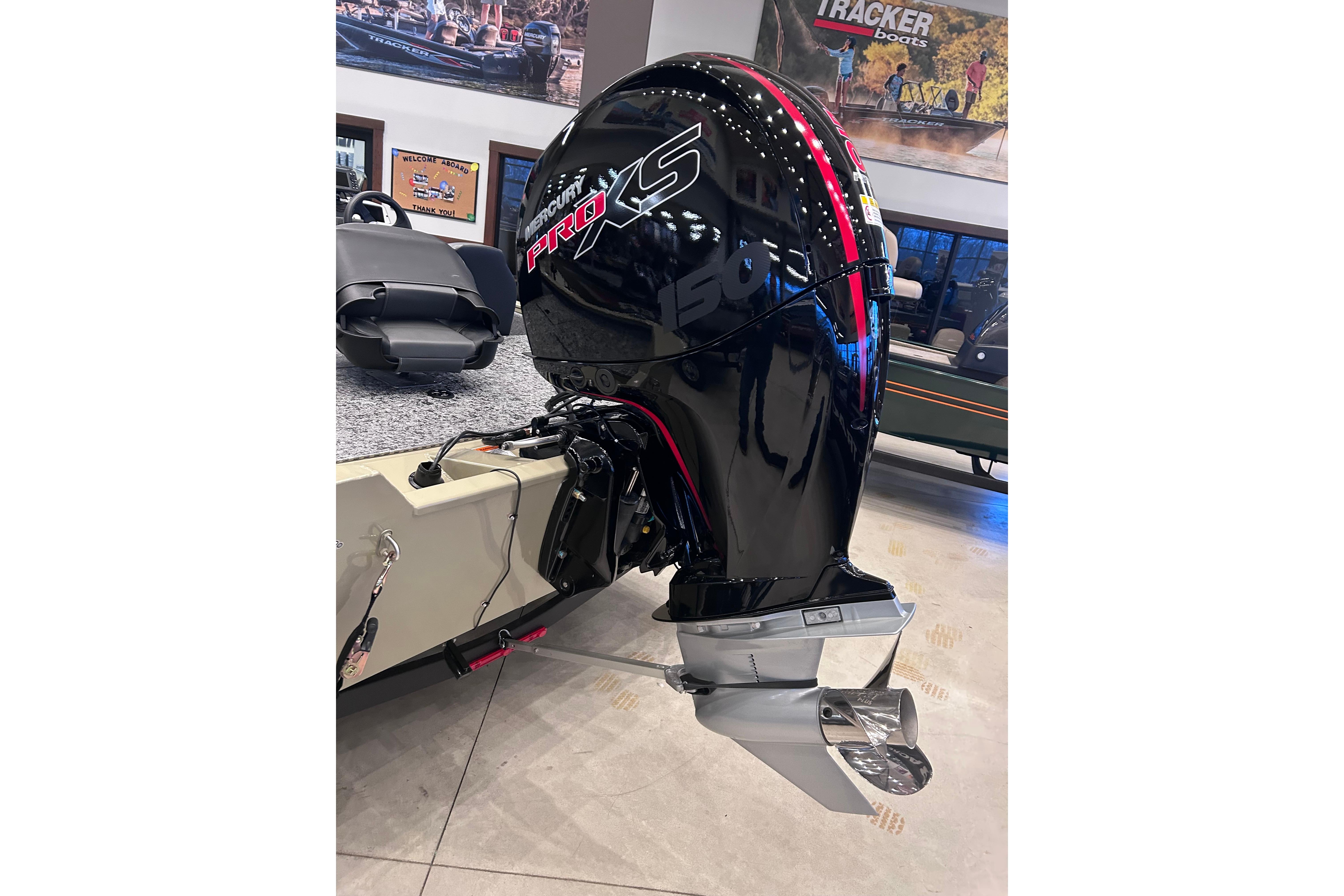 2026 Tracker Pro Team 195 boat with Mercury Pro XS 150 outboard motor in showroom.