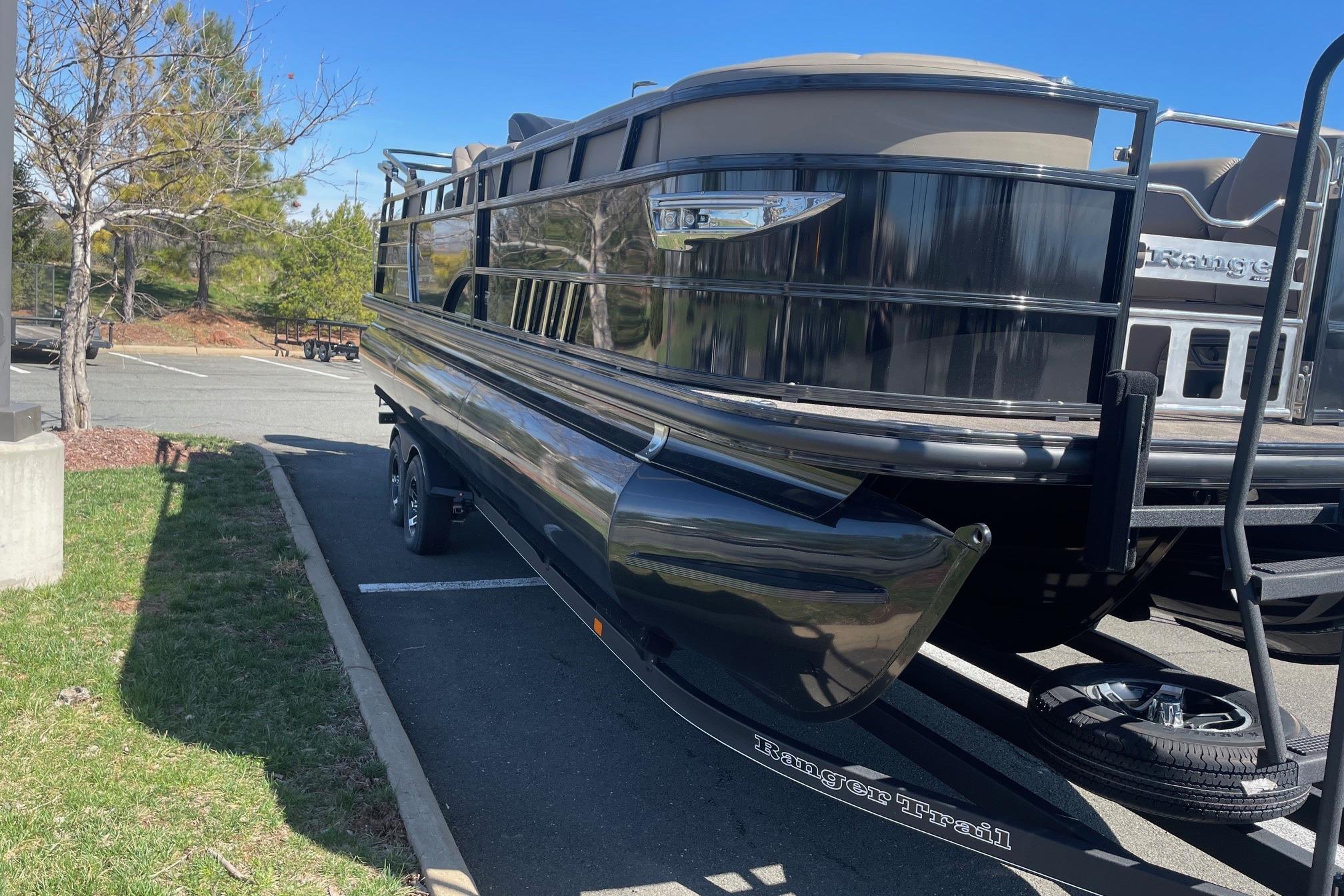 2024 Ranger 2500LS pontoon boat on trailer in sunny parking lot.
