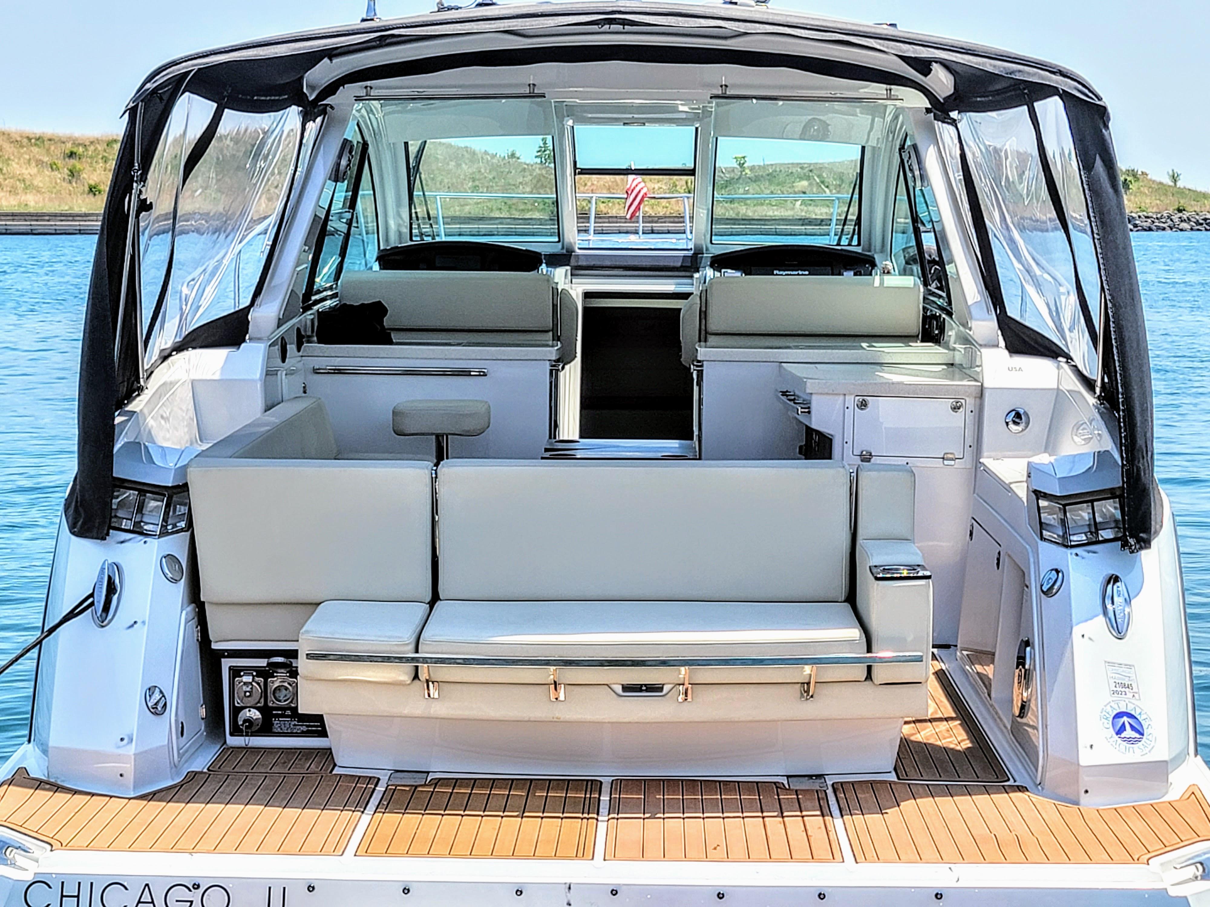 2017 Monterey 360 Sport Coupe boat interior with seating, docked on calm water.