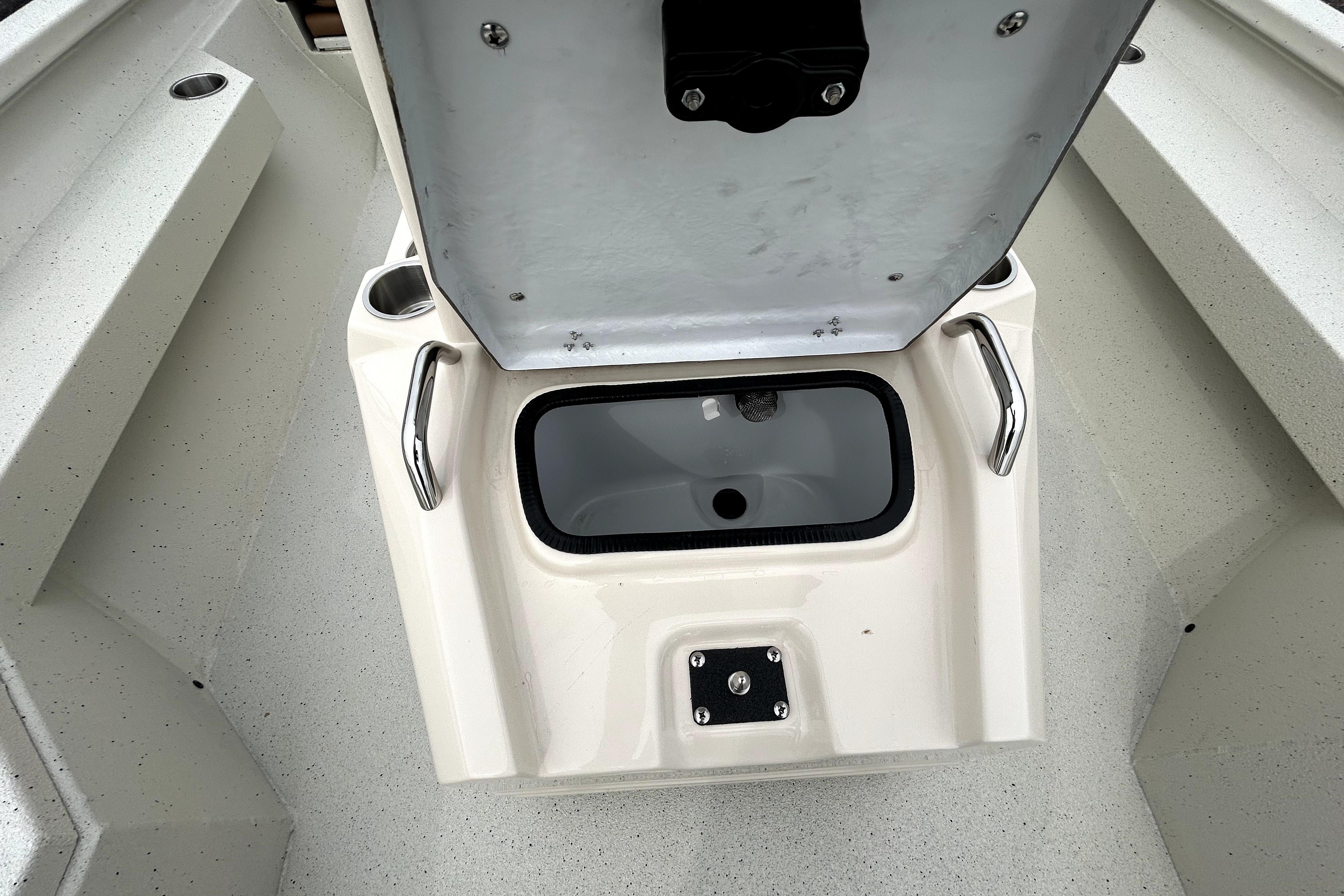 2026 Xpress H20B Bay boat interior with open storage compartment and cup holders.