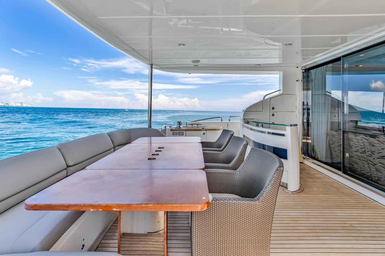 Luxurious 2012 Princess 85 yacht deck with ocean view, featuring elegant seating and dining area.
