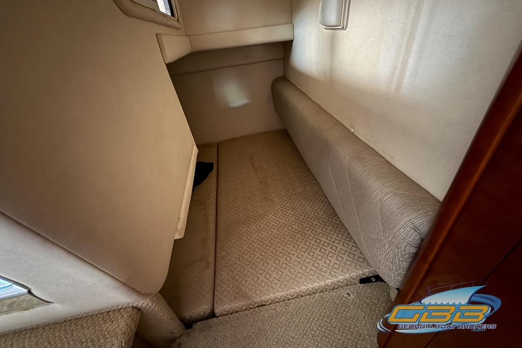 Interior cabin of 2006 Sea Ray Sundancer 260, featuring beige upholstery and compact design.