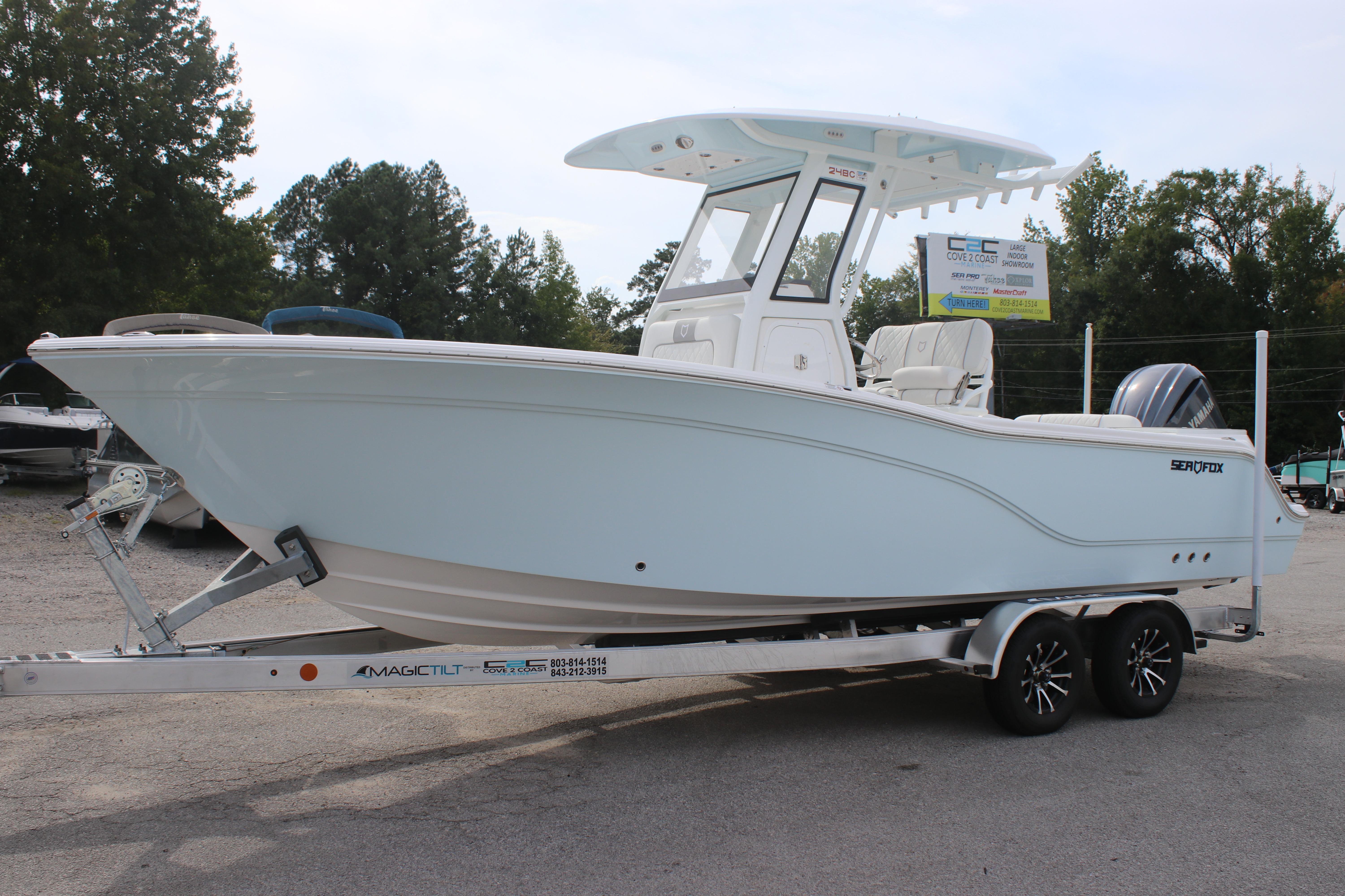 2026 Sea Fox 248 Commander boat on trailer, parked outdoors.