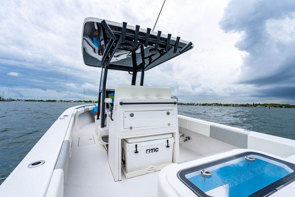 2027 Reef Runner 280 boat on water under cloudy sky, featuring a sleek design.