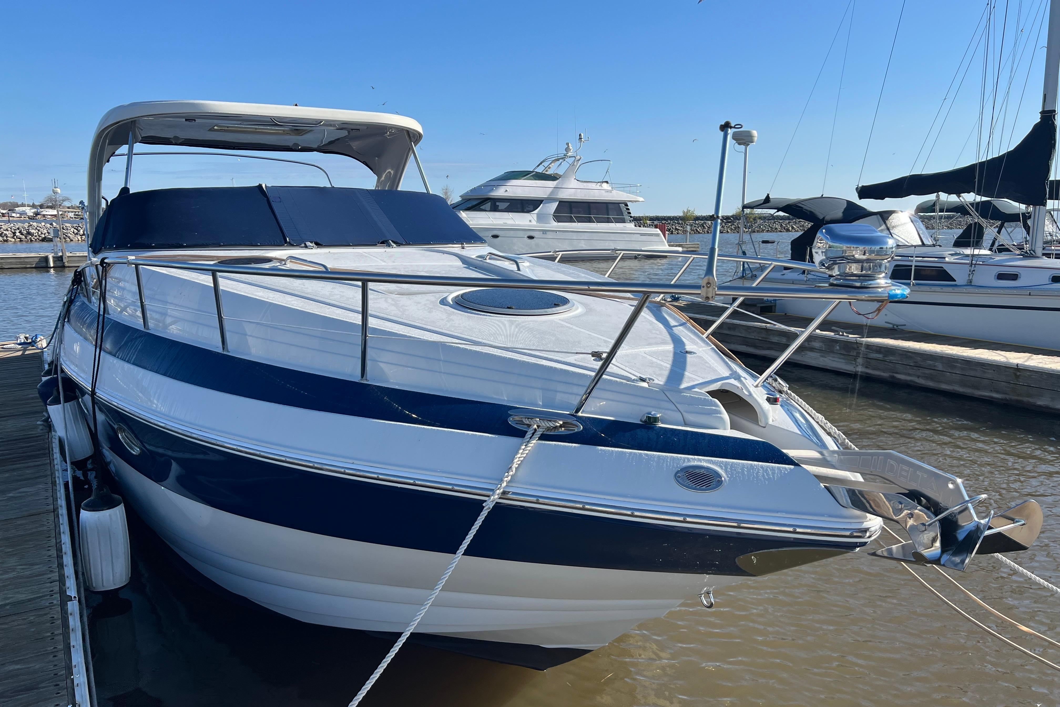 2008 Crownline 340 CR yacht docked at marina under clear blue sky.
