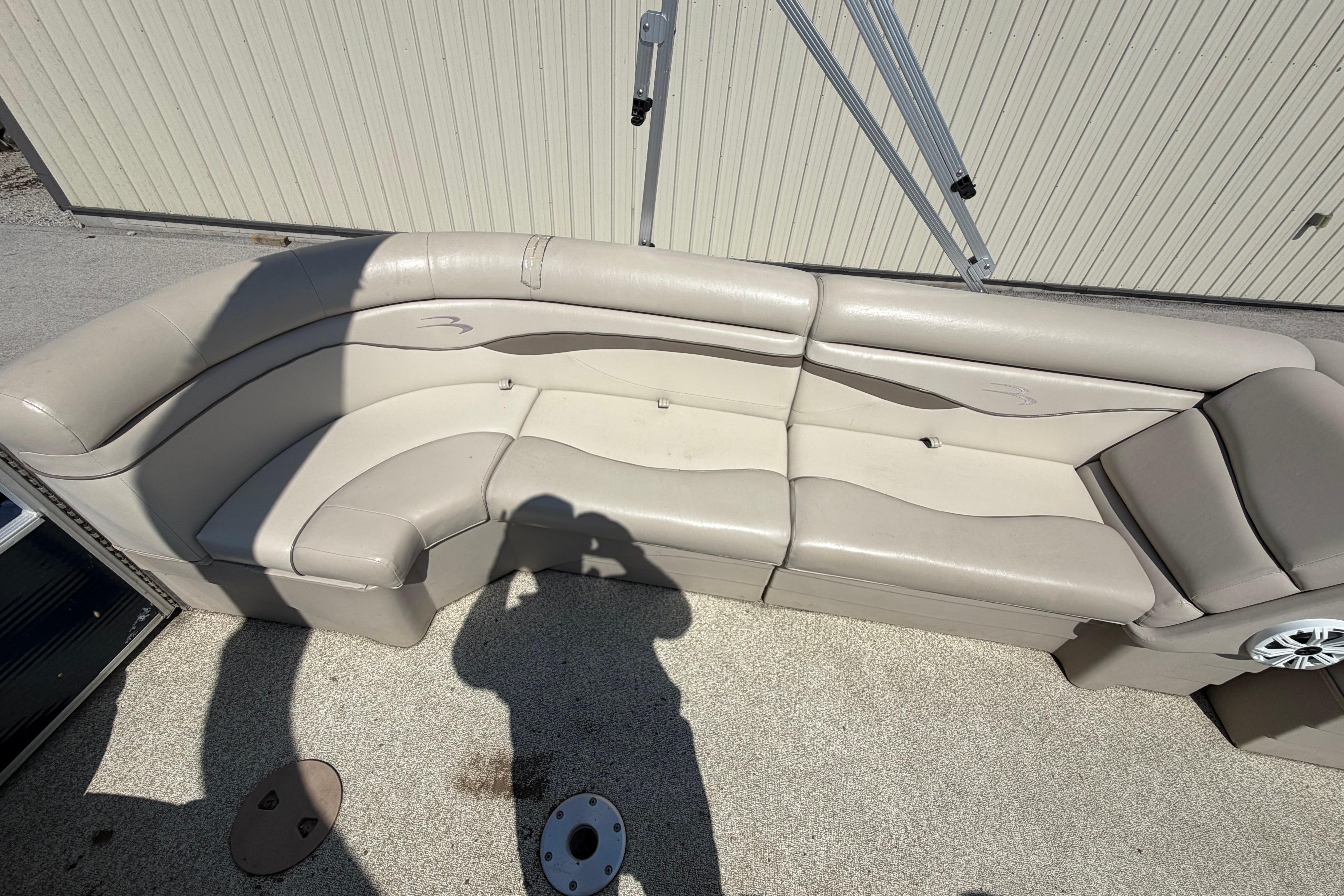 2017 Bennington 25 SSXAPG boat seating with beige upholstery and speaker detail.