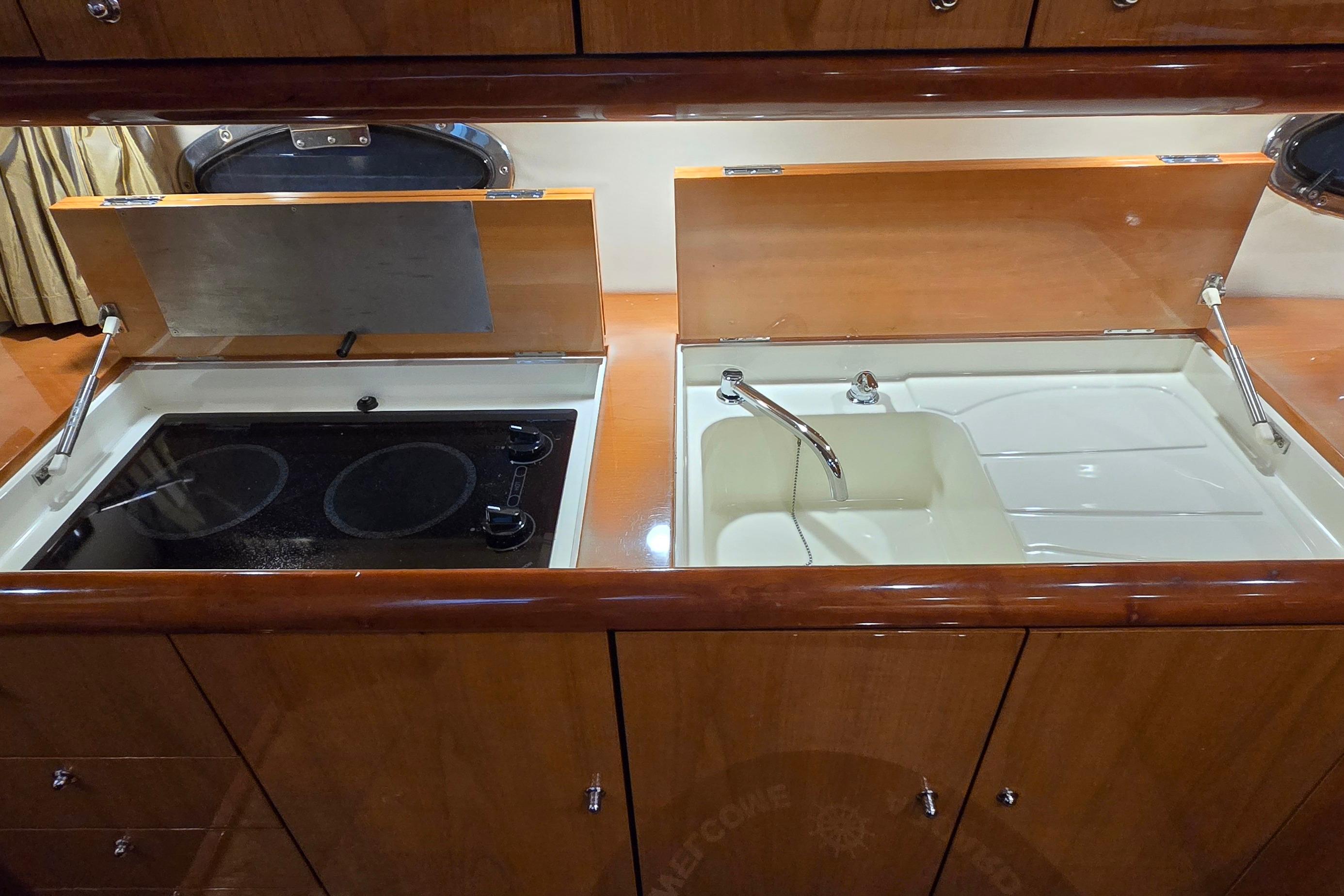 2004 Sunseeker Camargue 50 yacht kitchen with stove and sink.