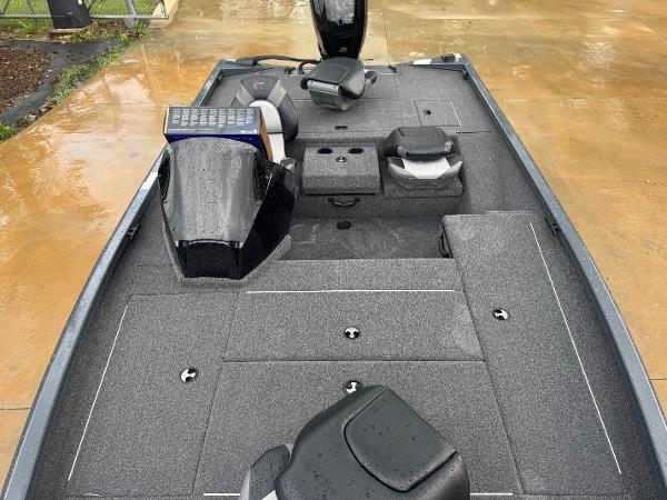 2025 Crestliner XF 179 boat interior with wet deck and seating, parked on wet pavement.