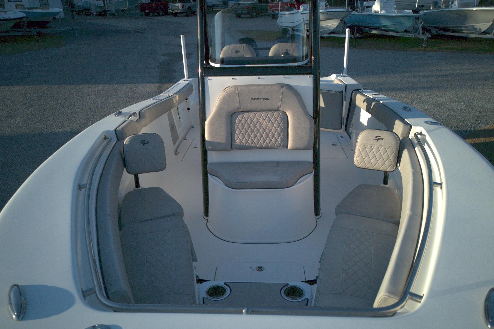 2021 Sea Pro 259 Center Console boat interior with cushioned seating and console.