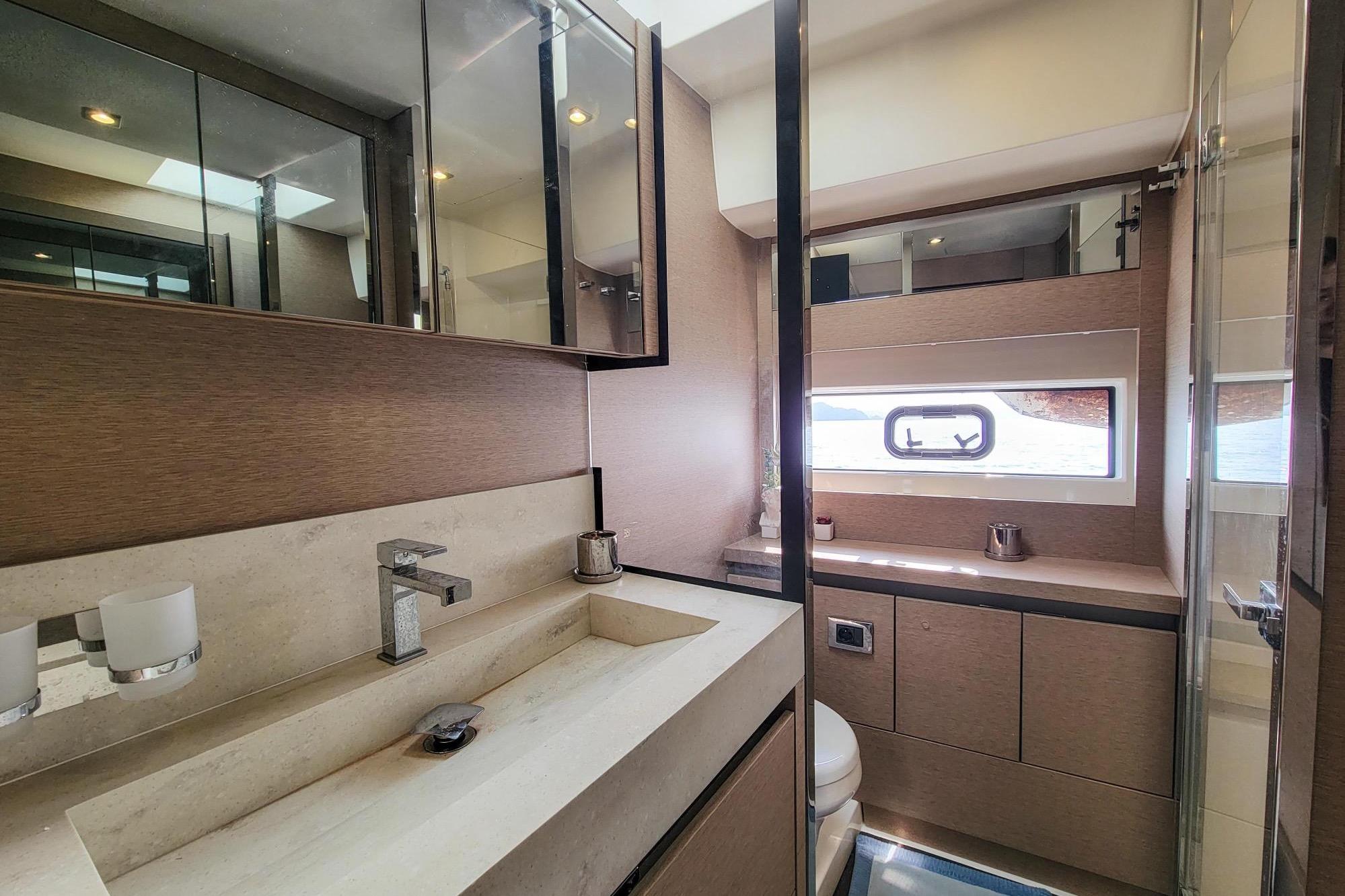 Luxurious bathroom interior of 2019 Prestiage 630 yacht with modern fixtures and ample lighting.