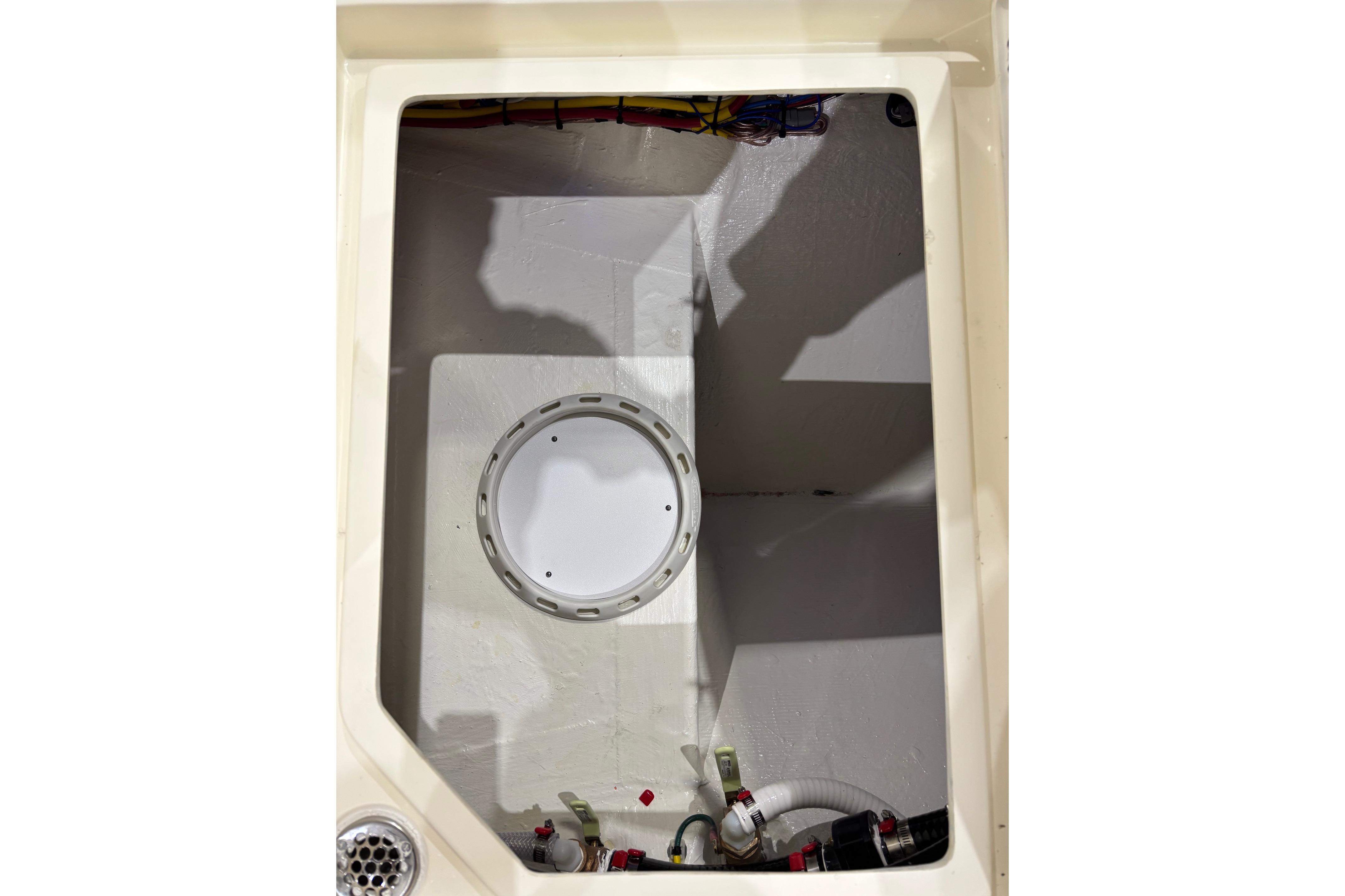 Interior view of 2026 Cobia 285 Open Center Console boat compartment.