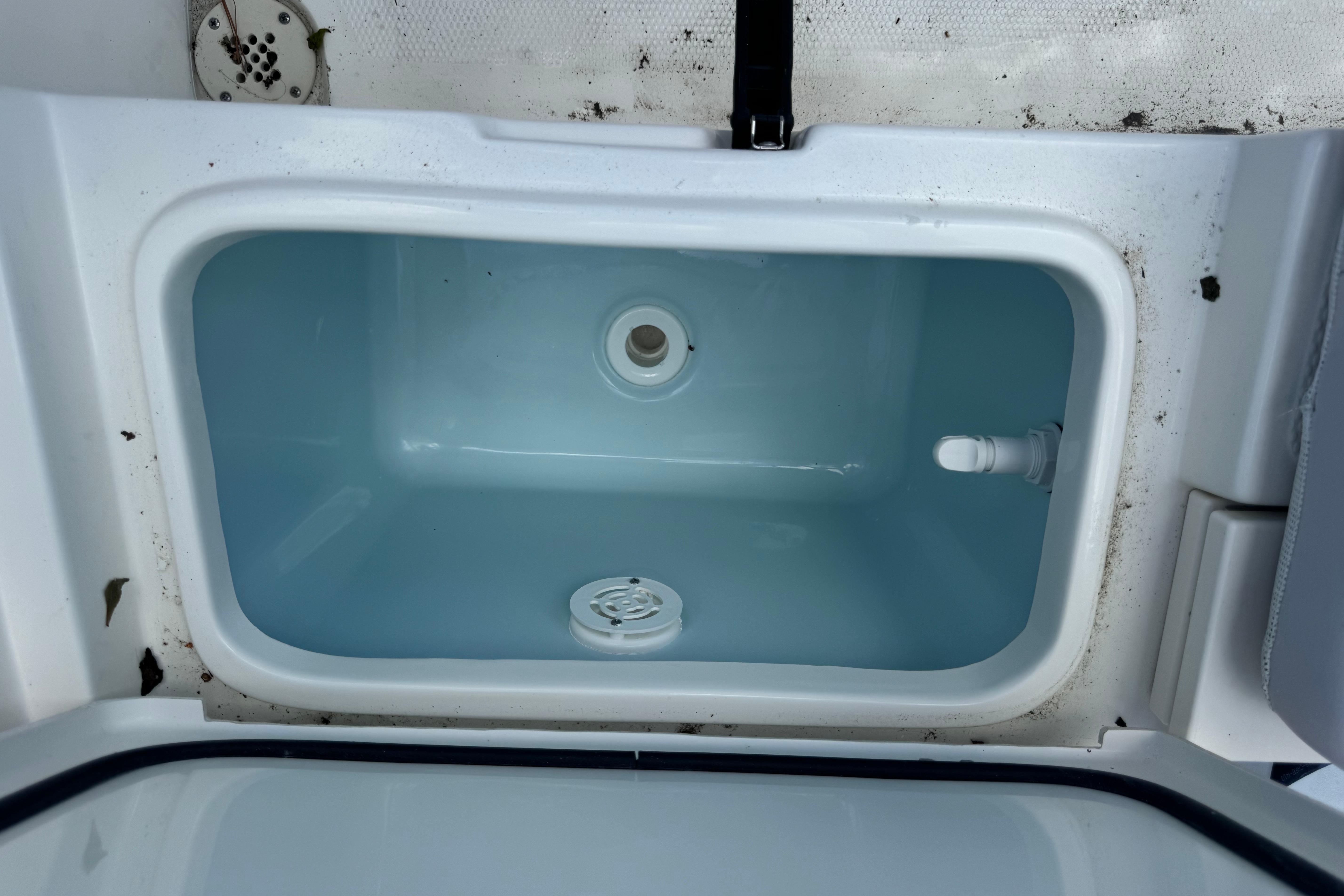 Livewell compartment in 2026 Mako 214 Center Console boat, clean and empty.