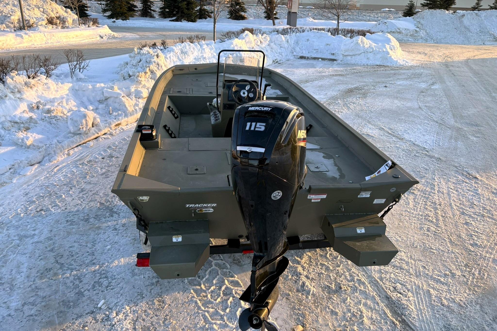 2024 Tracker Grizzly 2072 CC boat parked in snow.