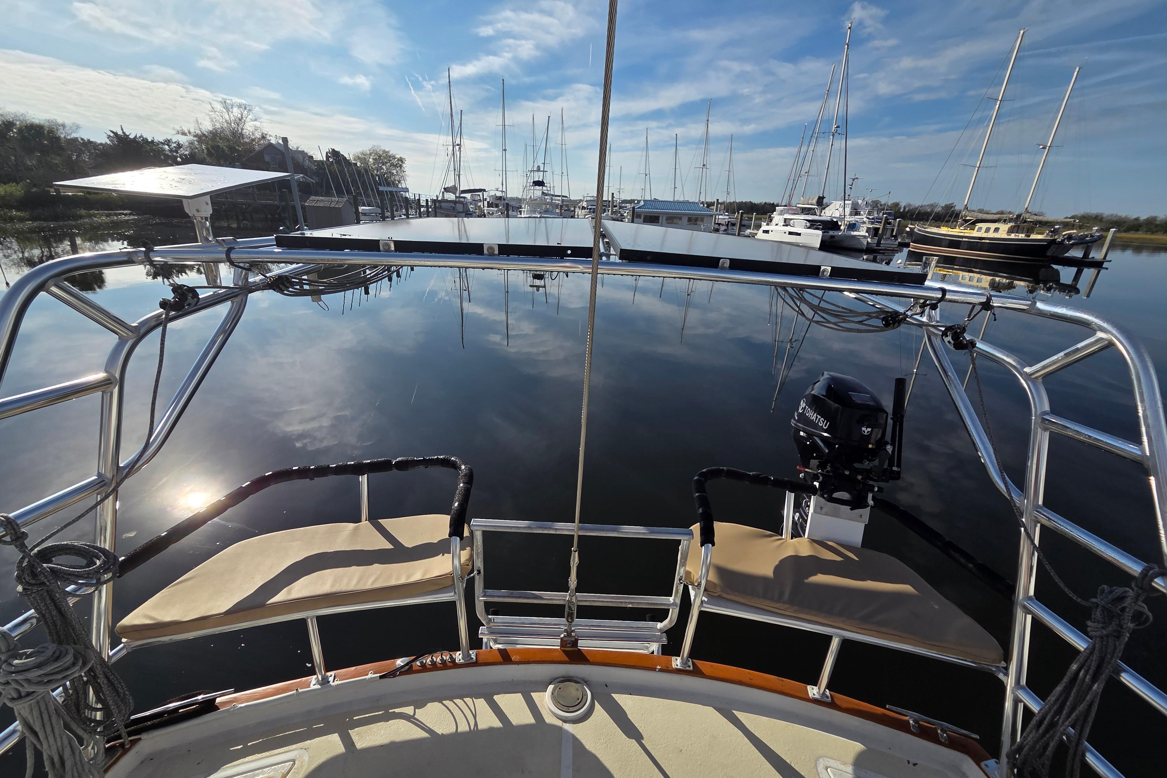 Cockpit view of 1985 Endeavour 51 sailboat docked in a serene marina.