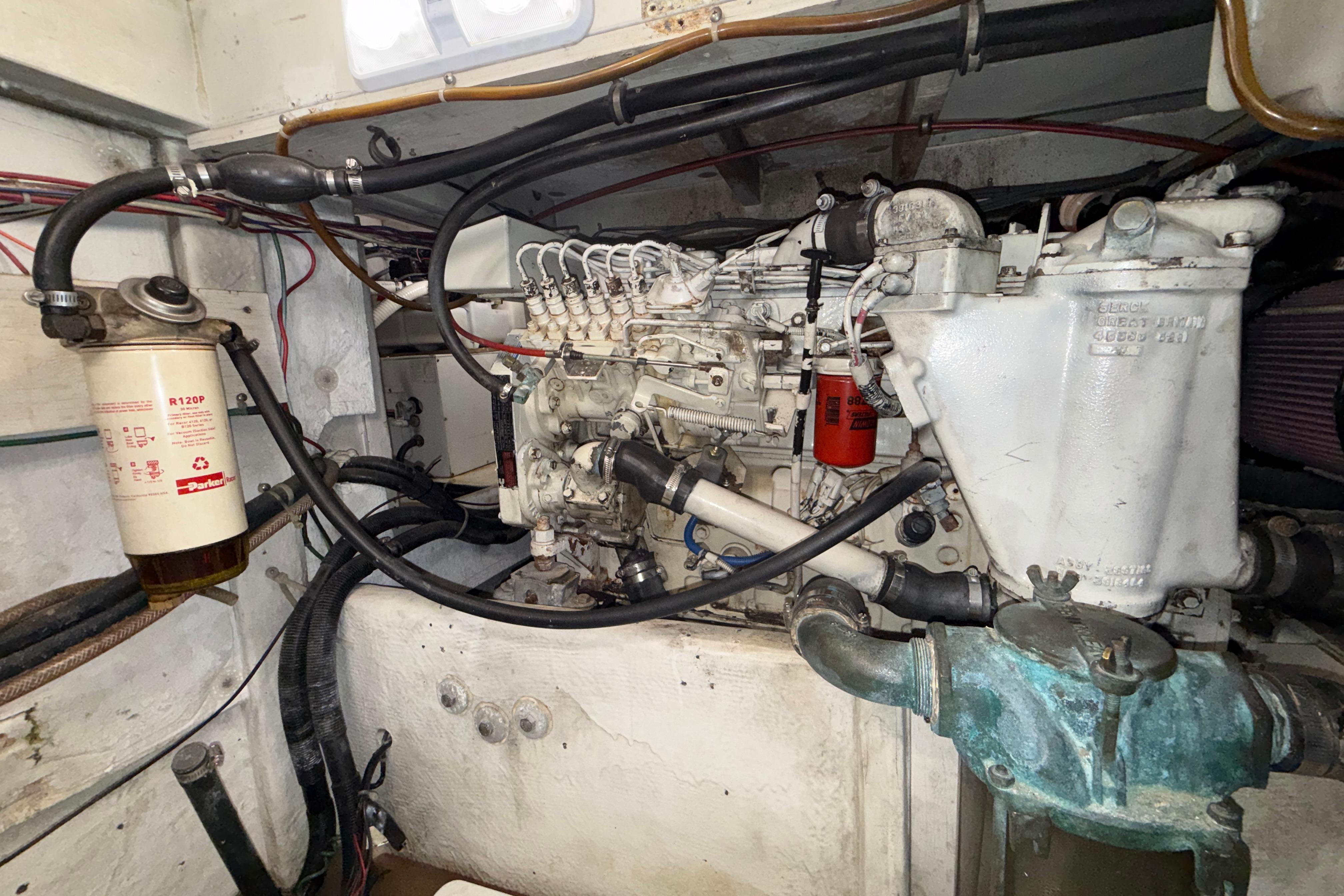 Engine compartment of a 1997 Bayliner 3988 Command Bridge Motoryacht, showcasing mechanical components.