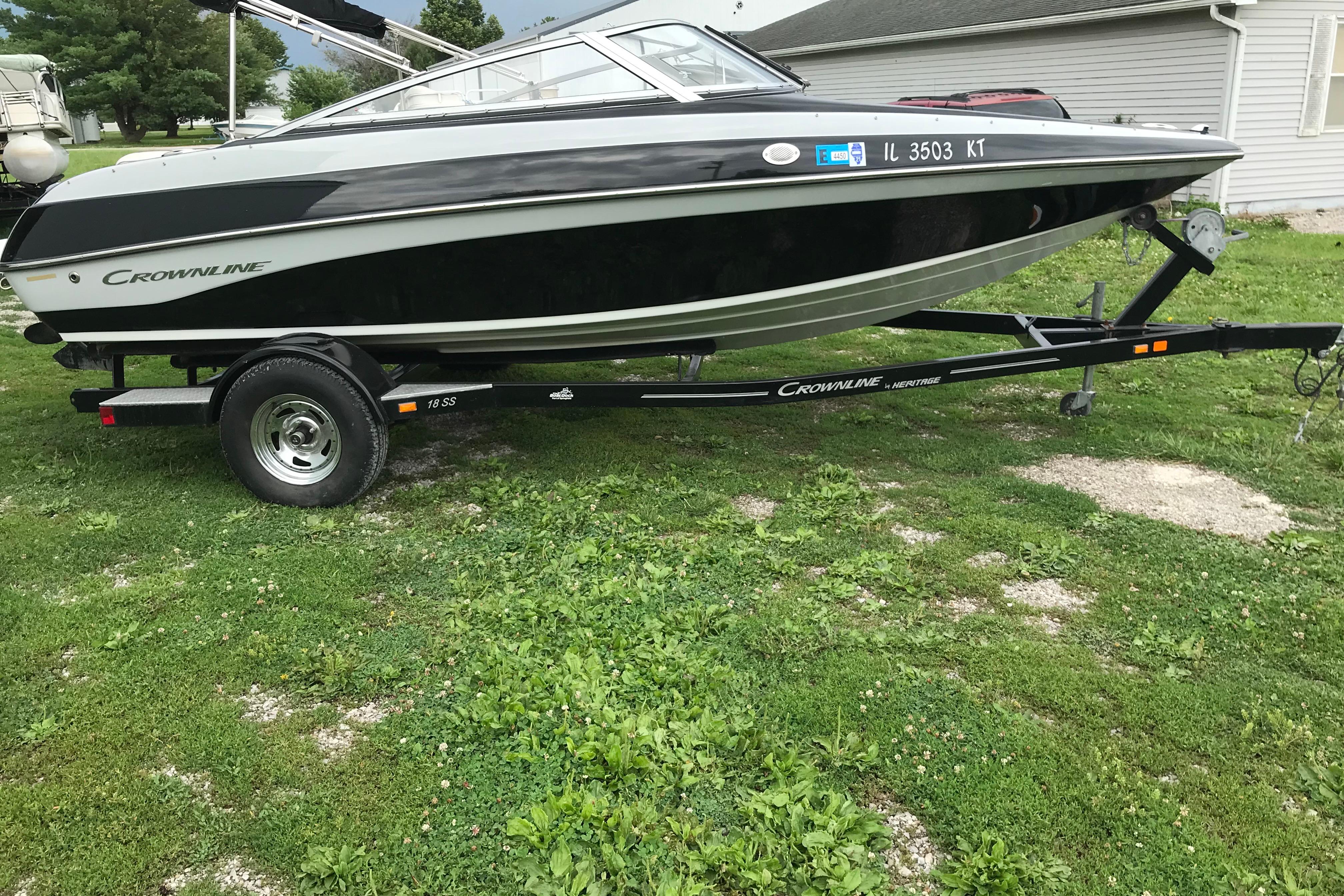 2015 Crownline 18 SS boat on trailer, parked on grassy area.
