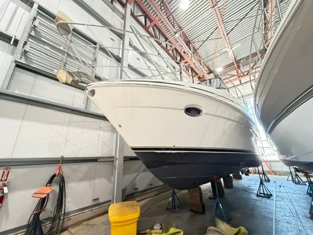 A 2005 Carver 44 Cockpit Motor Yacht is propped up in a storage facility.
