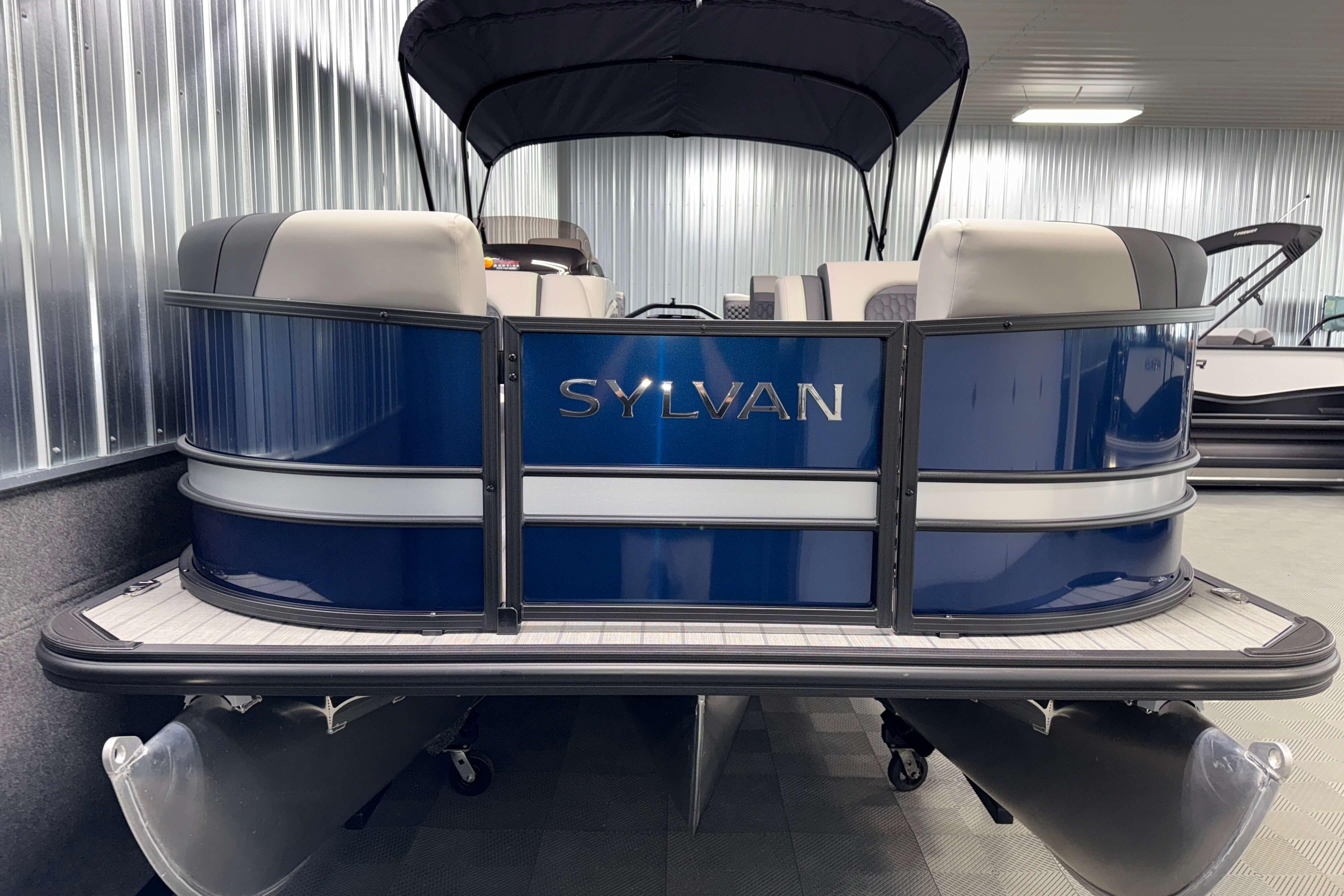 2026 Sylvan L3 SLZ pontoon boat with blue exterior in showroom.