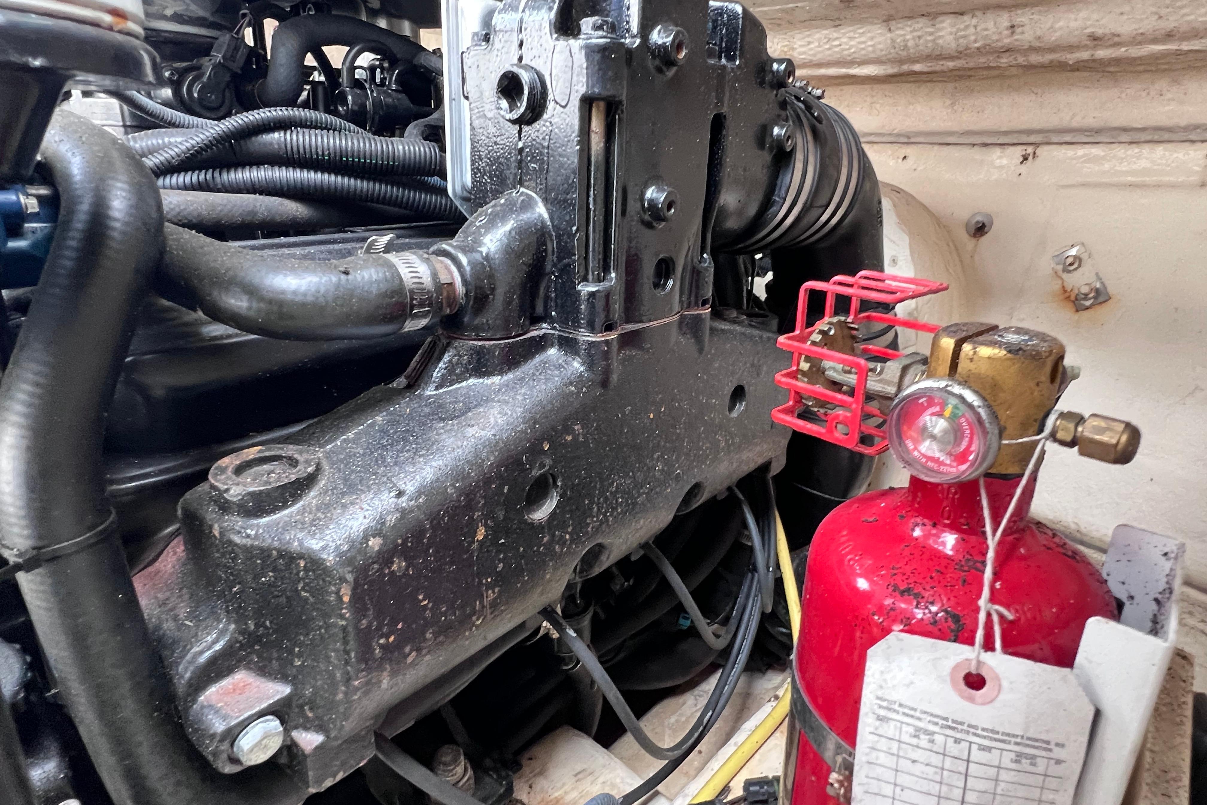 Engine compartment of a 2004 Chaparral Sunesta 254 with fire extinguisher.