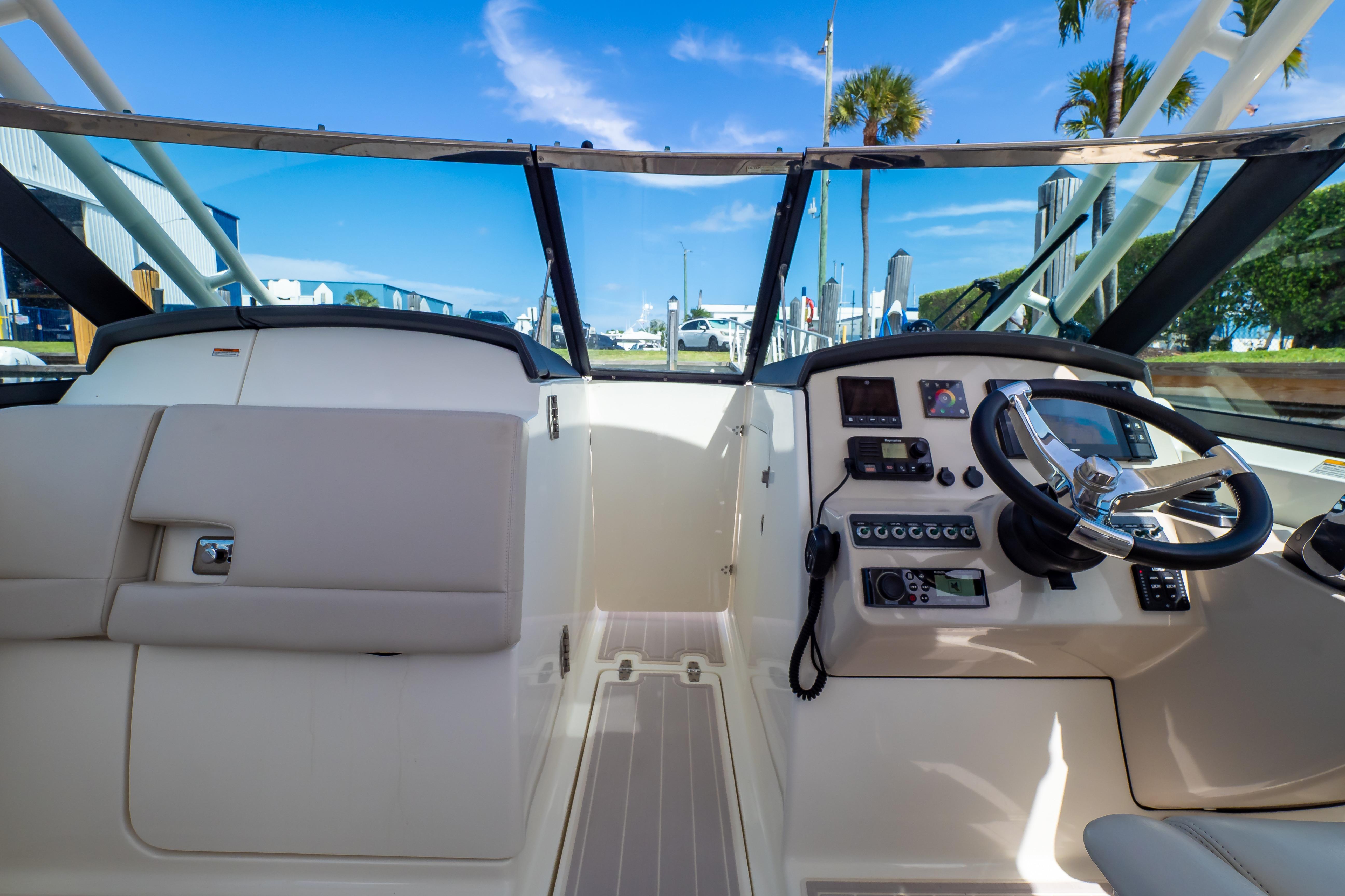 2019 Boston Whaler 270 Vantage cockpit with steering wheel and control panel.