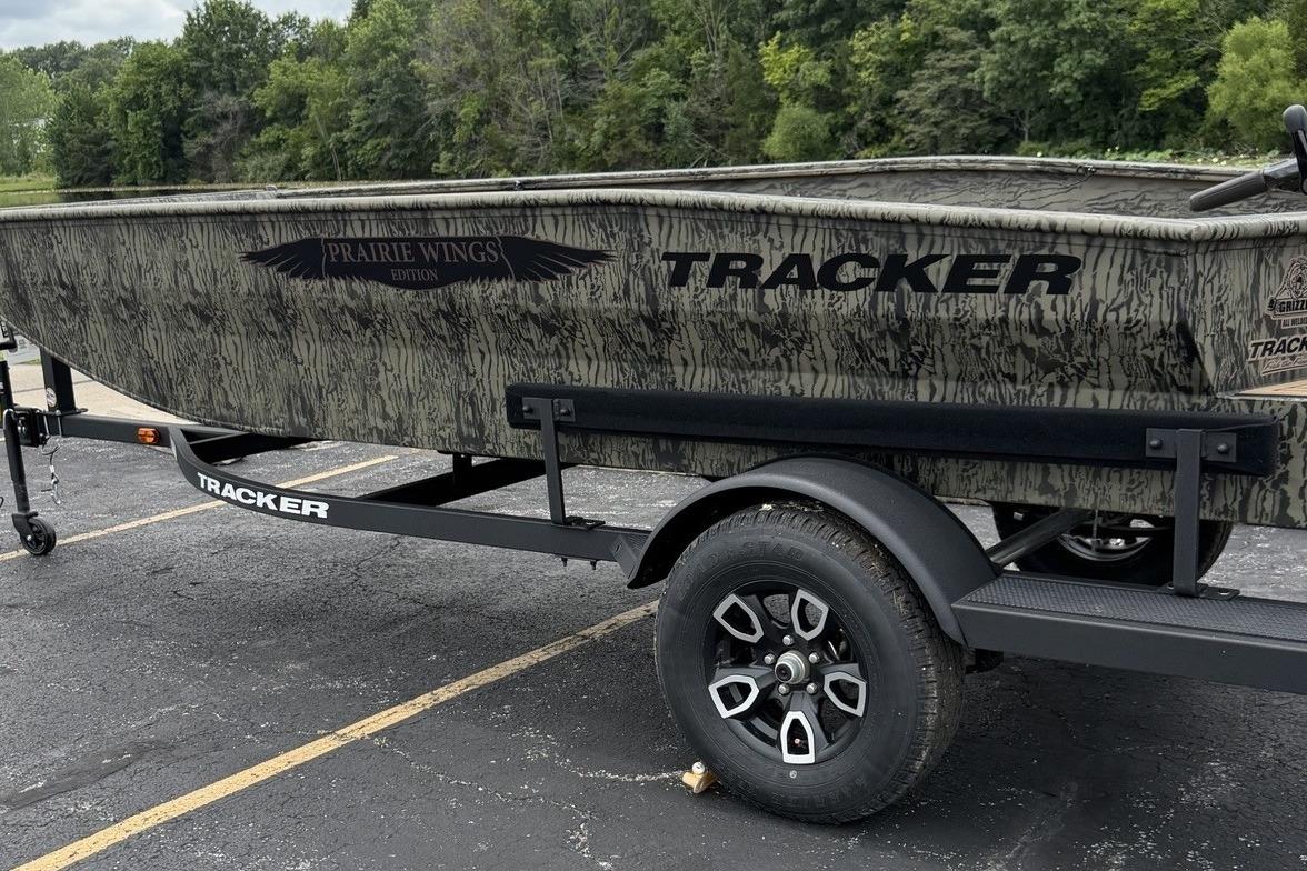 2026 Tracker Grizzly 1650 T Prairie Wings Edition boat on trailer in parking lot.