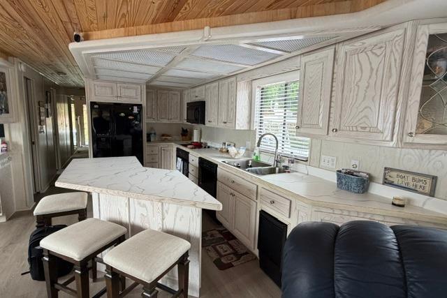 Interior of 1997 Stardust Houseboat 18x83 with modern kitchen and wooden accents.