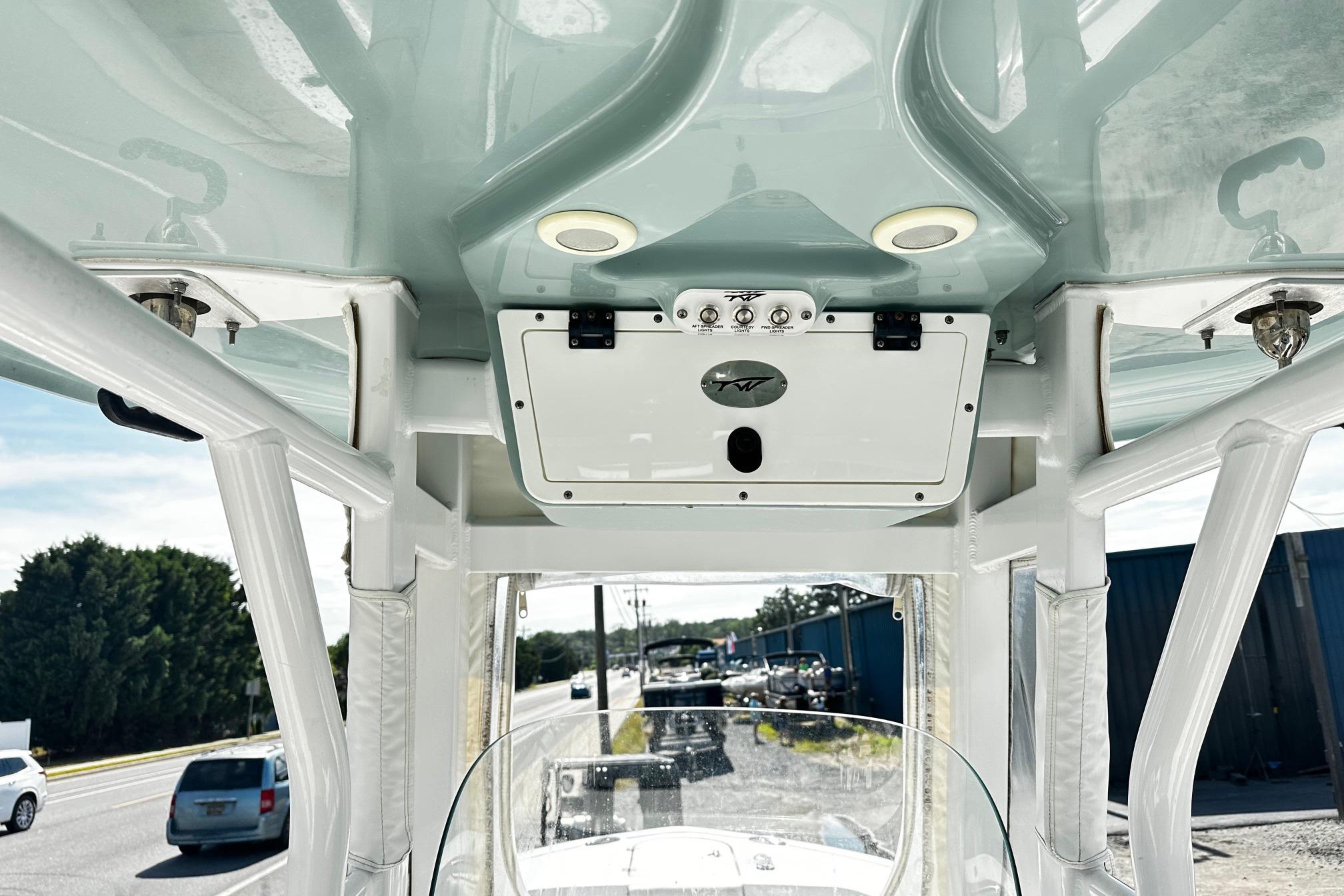 2020 Tidewater 230 CC Adventure boat console with overhead storage and controls.