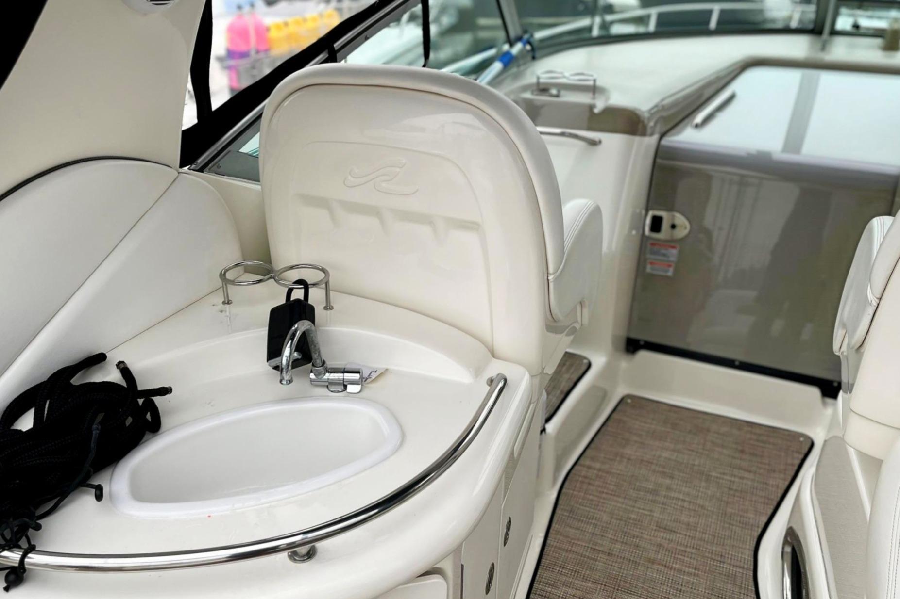 2006 Sea Ray 340 Sundancer interior with sink and seating area.
