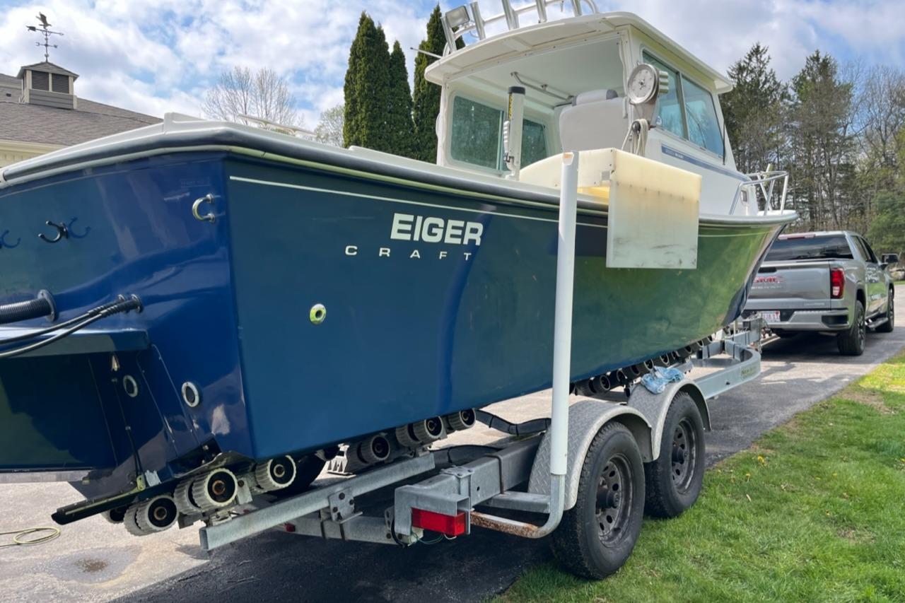 2012 Steiger Craft Miami boat on trailer, parked outdoors near a truck.