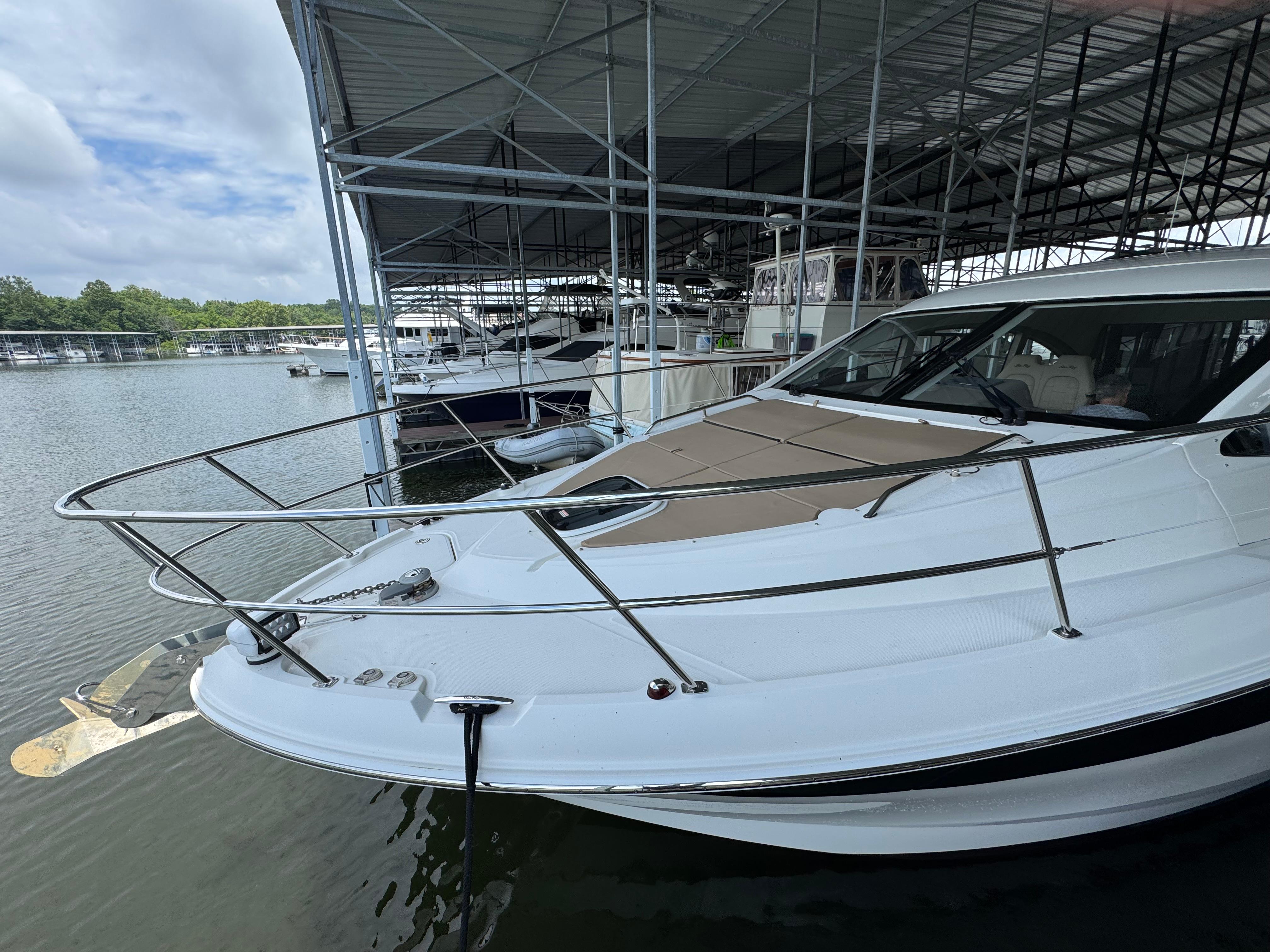 2017 Sea Ray Sundancer 400 docked in a marina under a covered structure.
