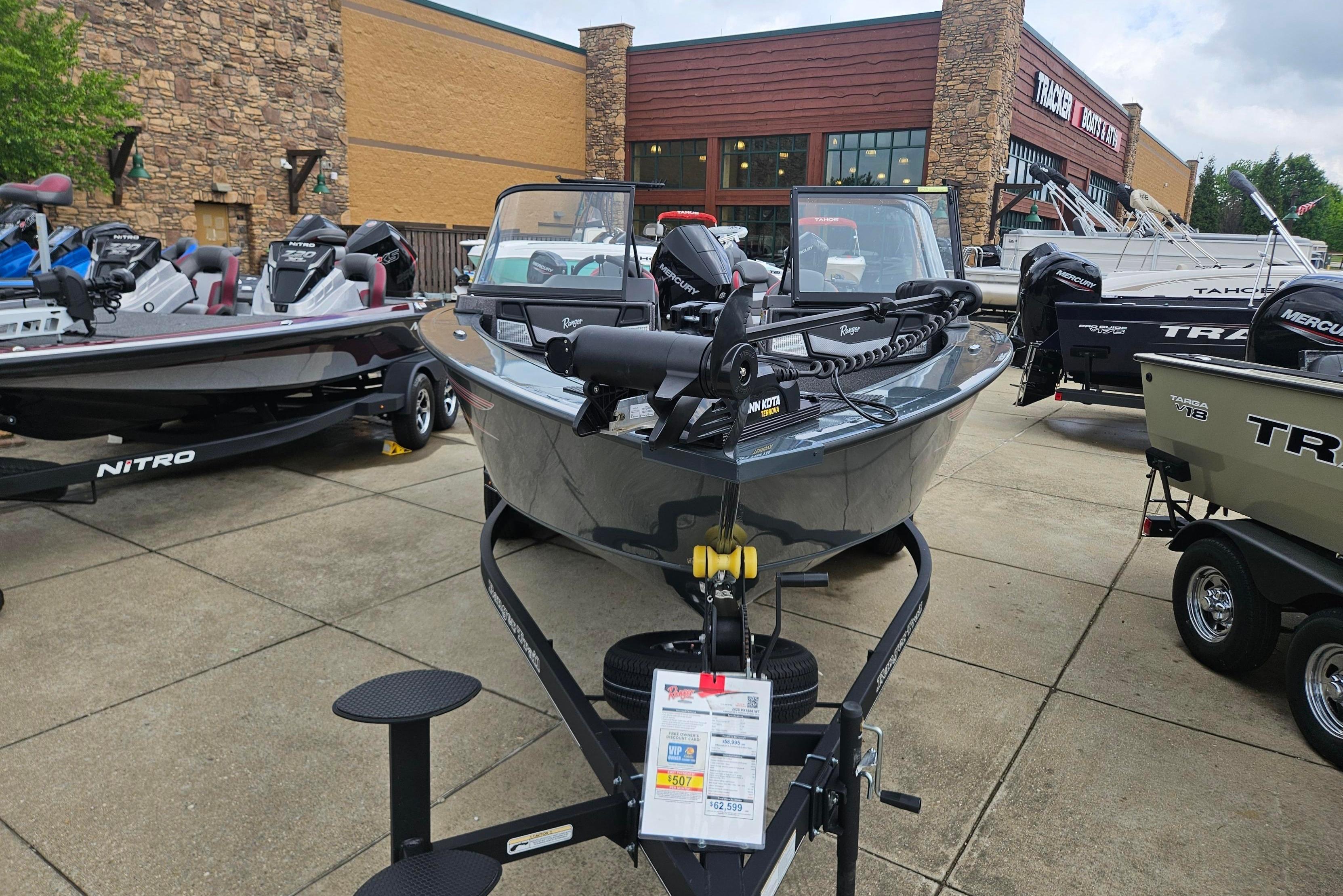 2025 Ranger VX1888 WT boat displayed at a dealership, surrounded by other models.