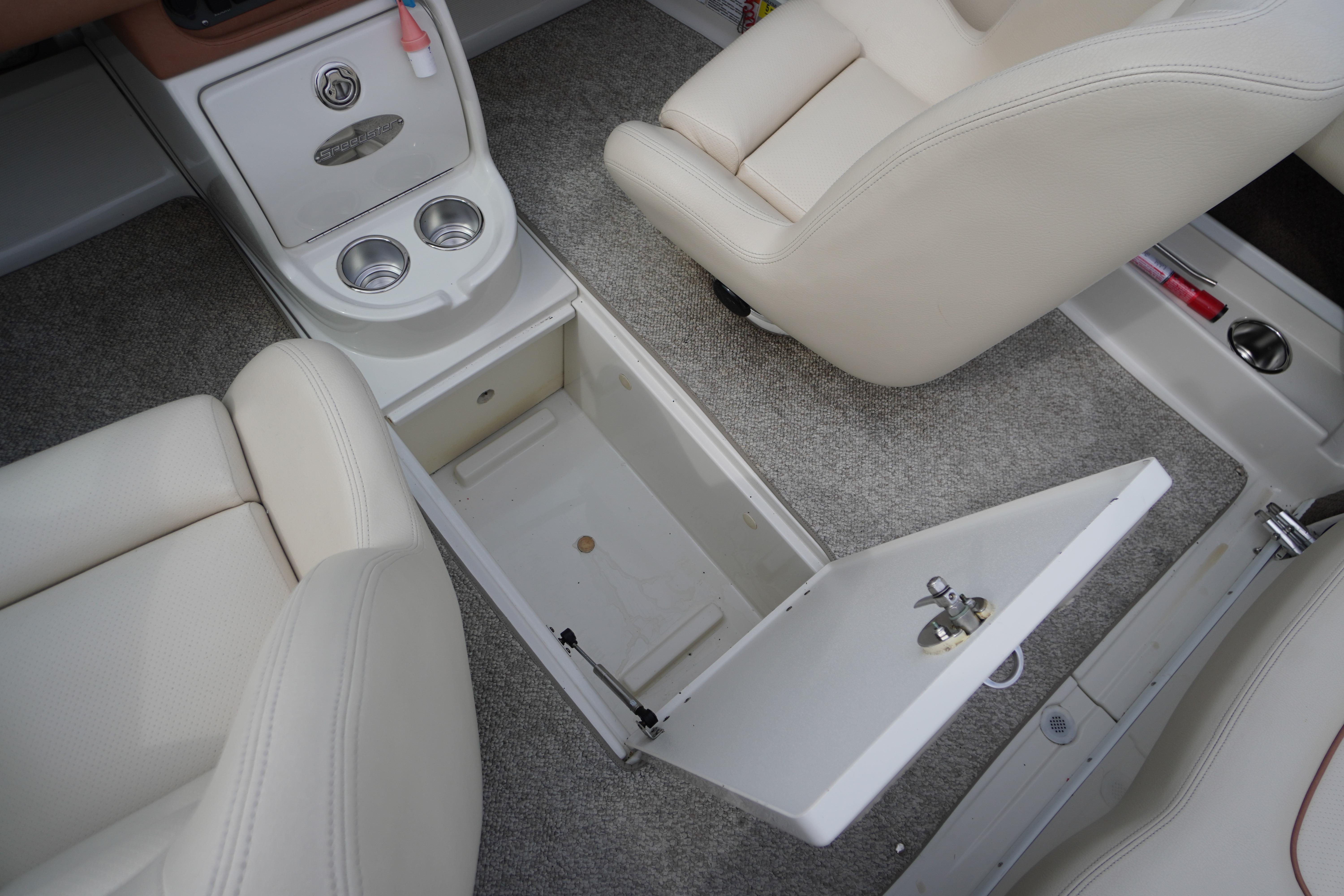 2005 Chris Craft Speedster Heritage interior with open storage compartment and cup holders.