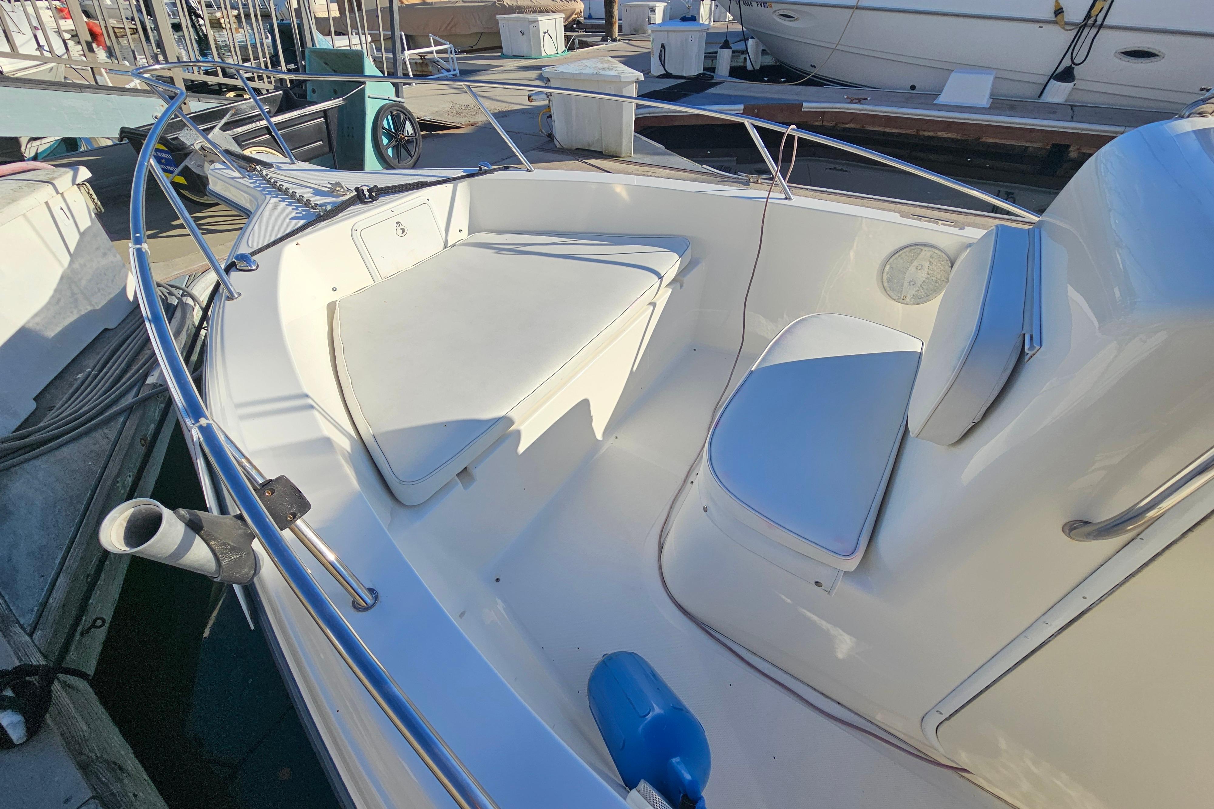 2002 Sea Fox 210 Center Console boat interior with white seating and railings.