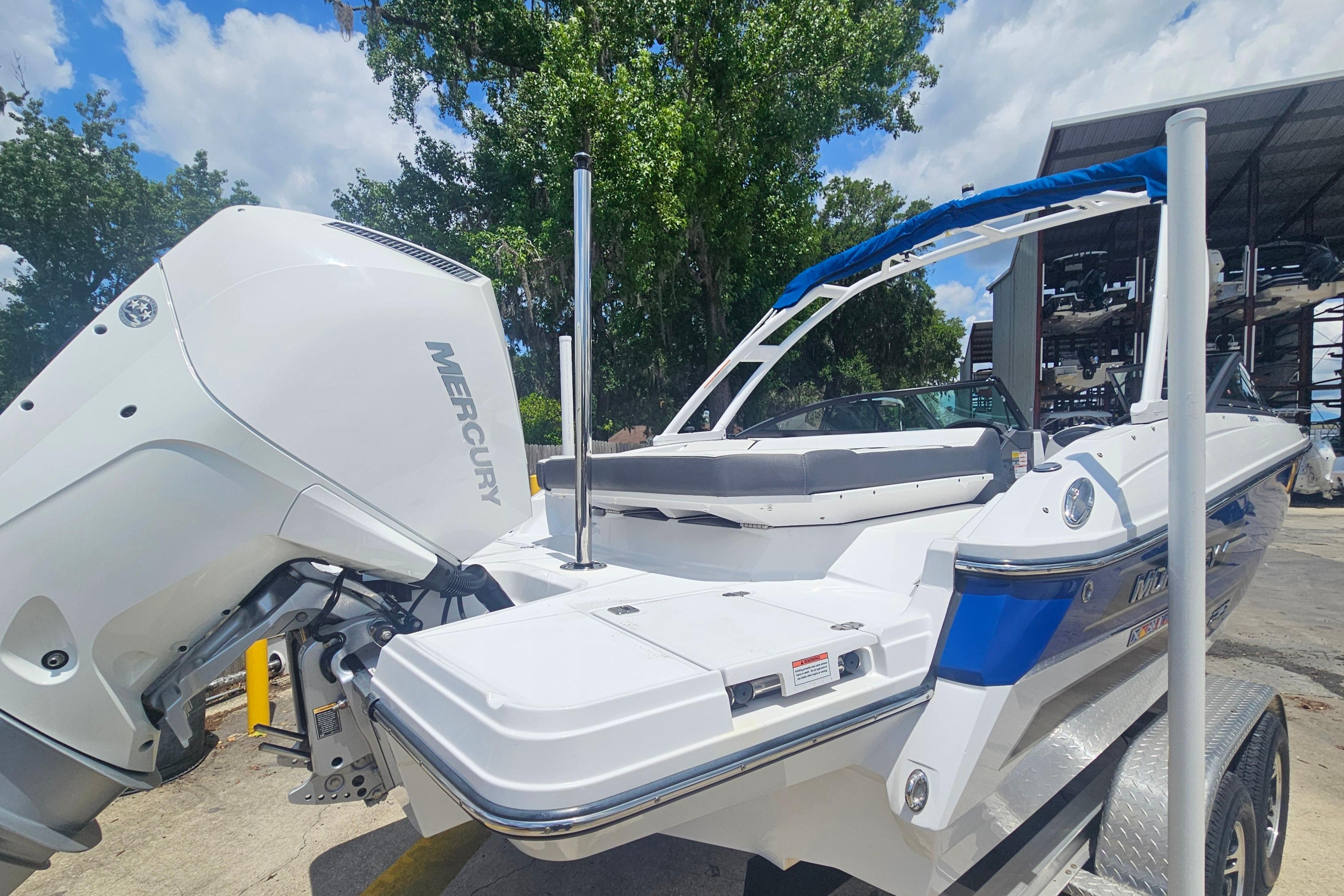 2024 Monterey 215SS Super Sport boat with Mercury engine, parked outdoors on a sunny day.