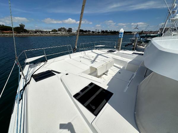 Bali 4.8 catamaran deck, 2021 model, docked in a marina under a clear sky.