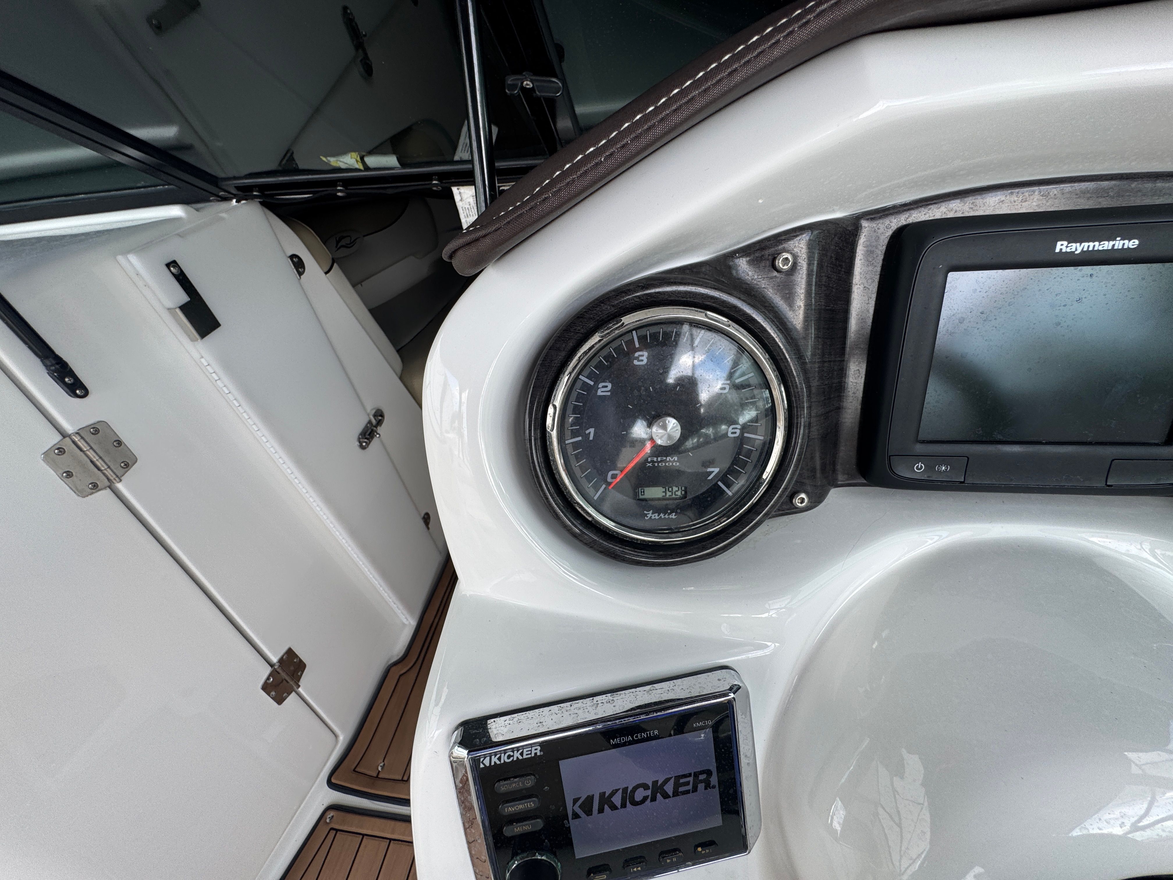 Dashboard of a 2017 Rinker QX29 BR boat with tachometer and Raymarine display.