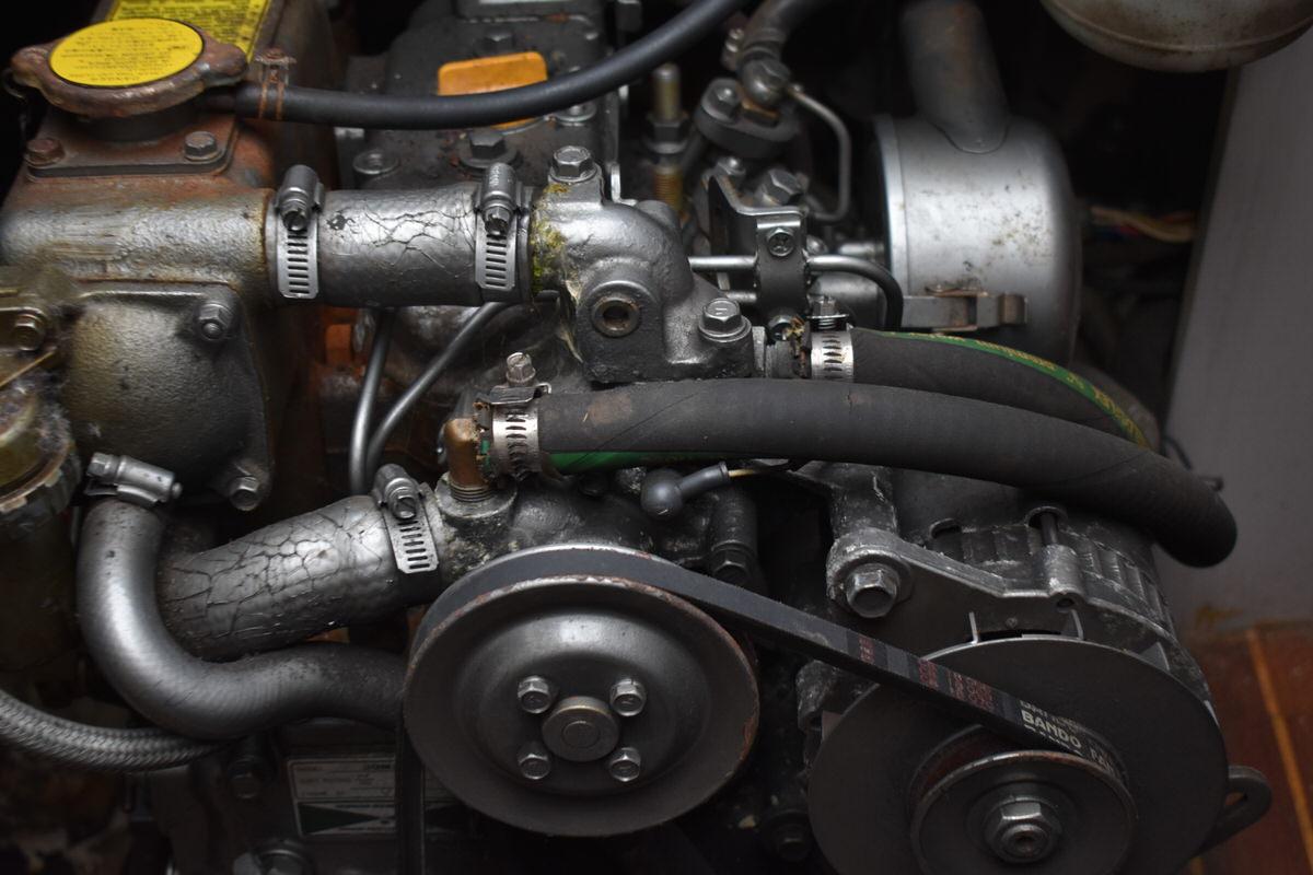 Engine of a 1987 S2 9.2A sailboat with belts and hoses.