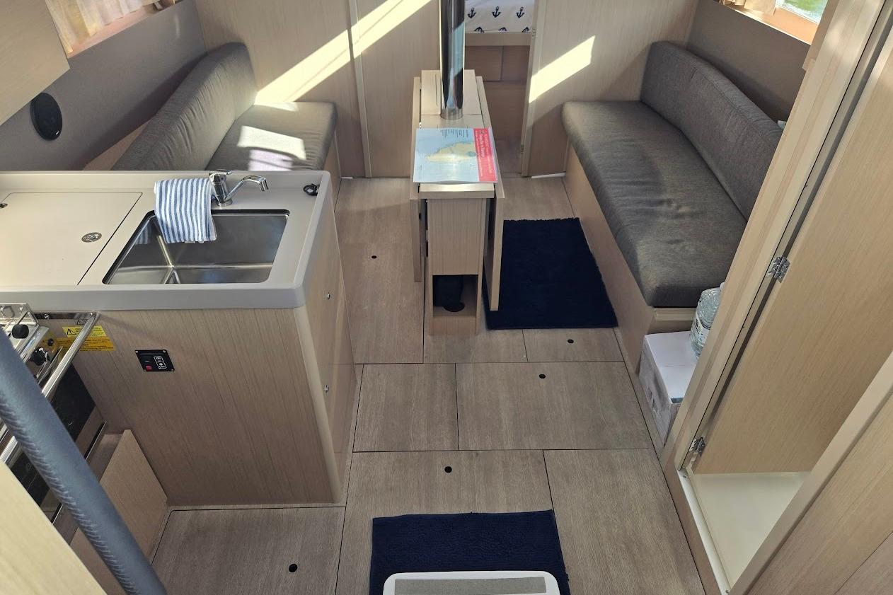 2023 Beneteau Oceanis 38.1 interior with modern kitchen and seating area.