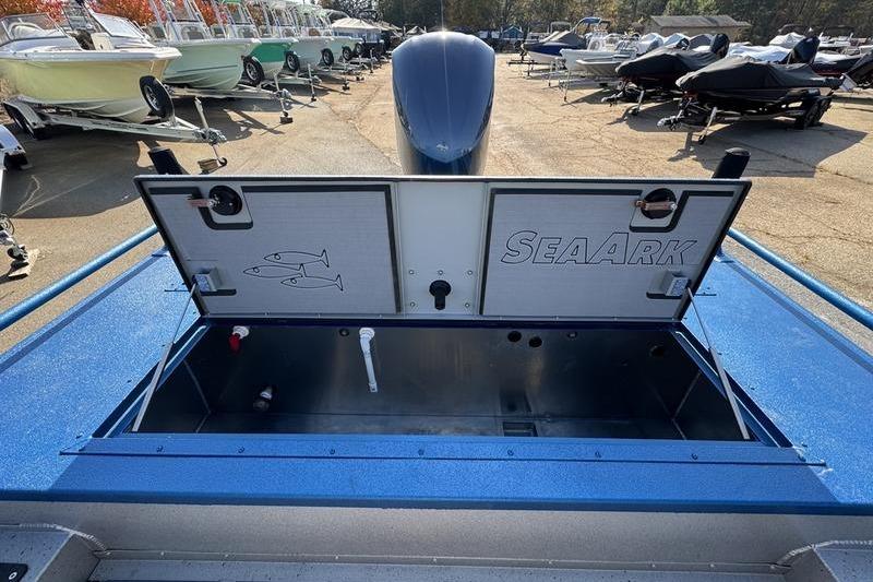 2026 SeaArk Dynasty 2.0 boat with open storage compartment in a boatyard.