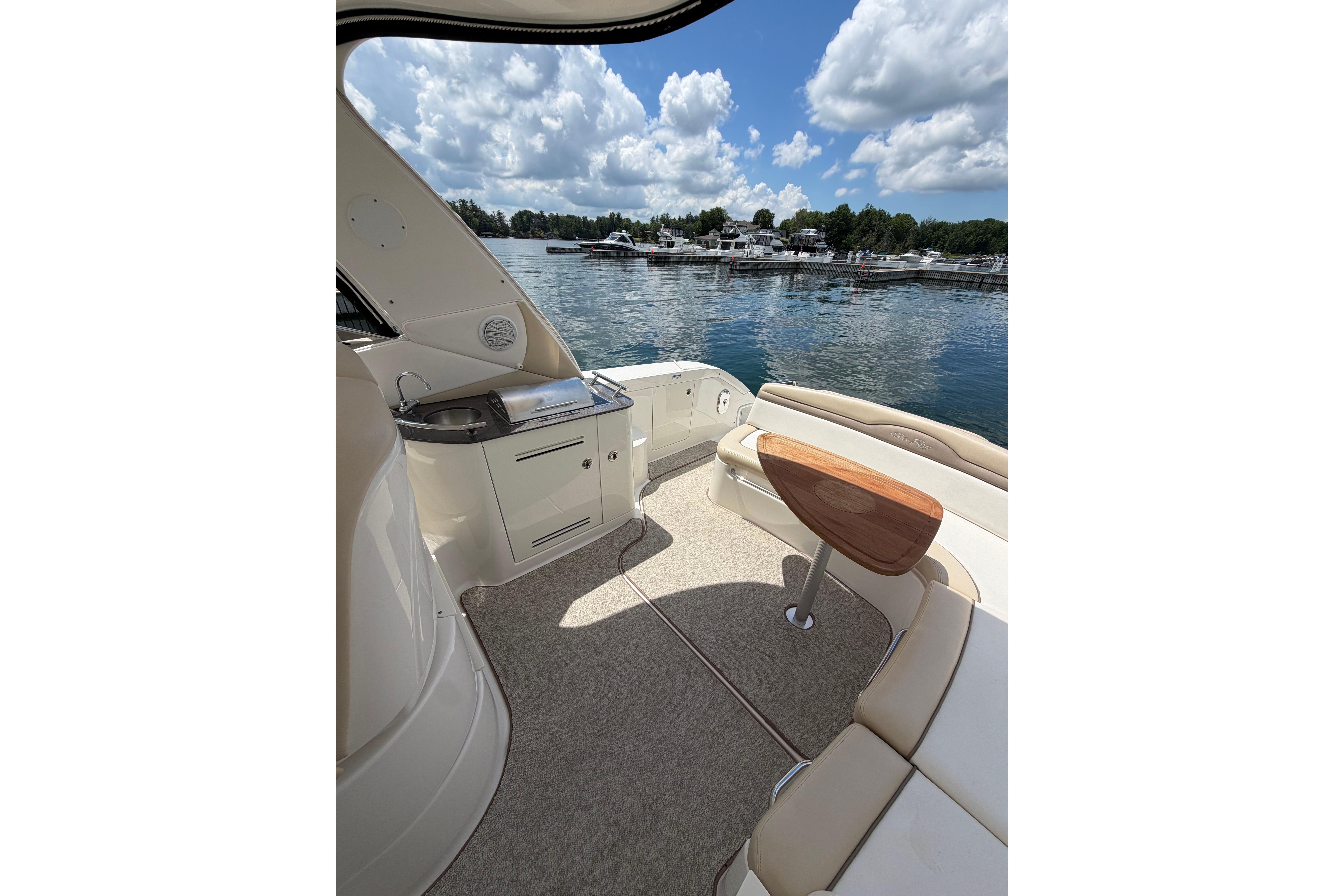 Interior view of 2012 Sea Ray Sundancer 370 yacht with scenic marina backdrop.