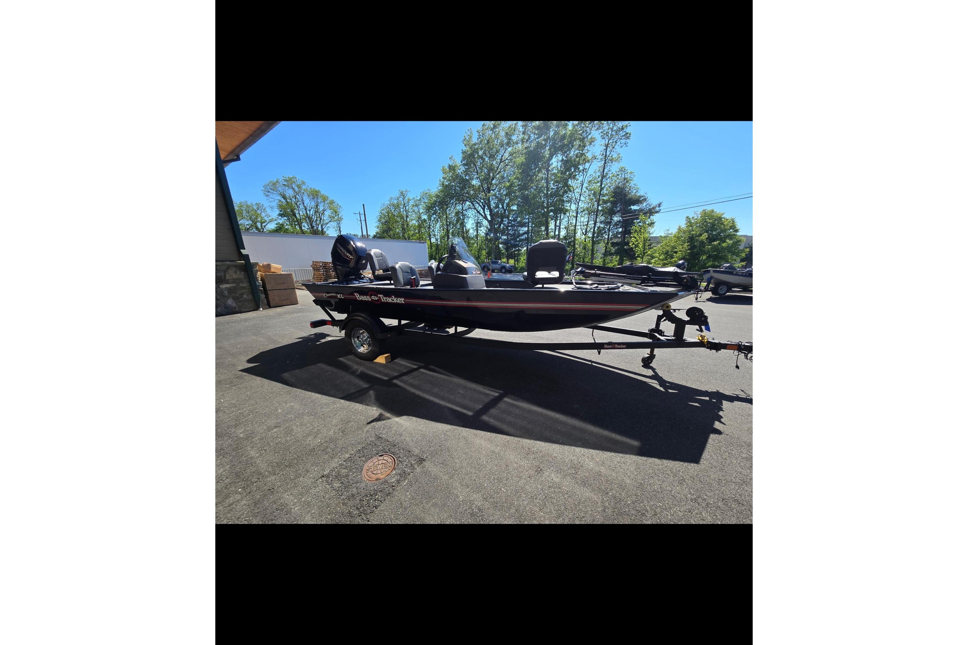 2024 Tracker Bass Tracker Classic XL boat on trailer, parked outdoors.