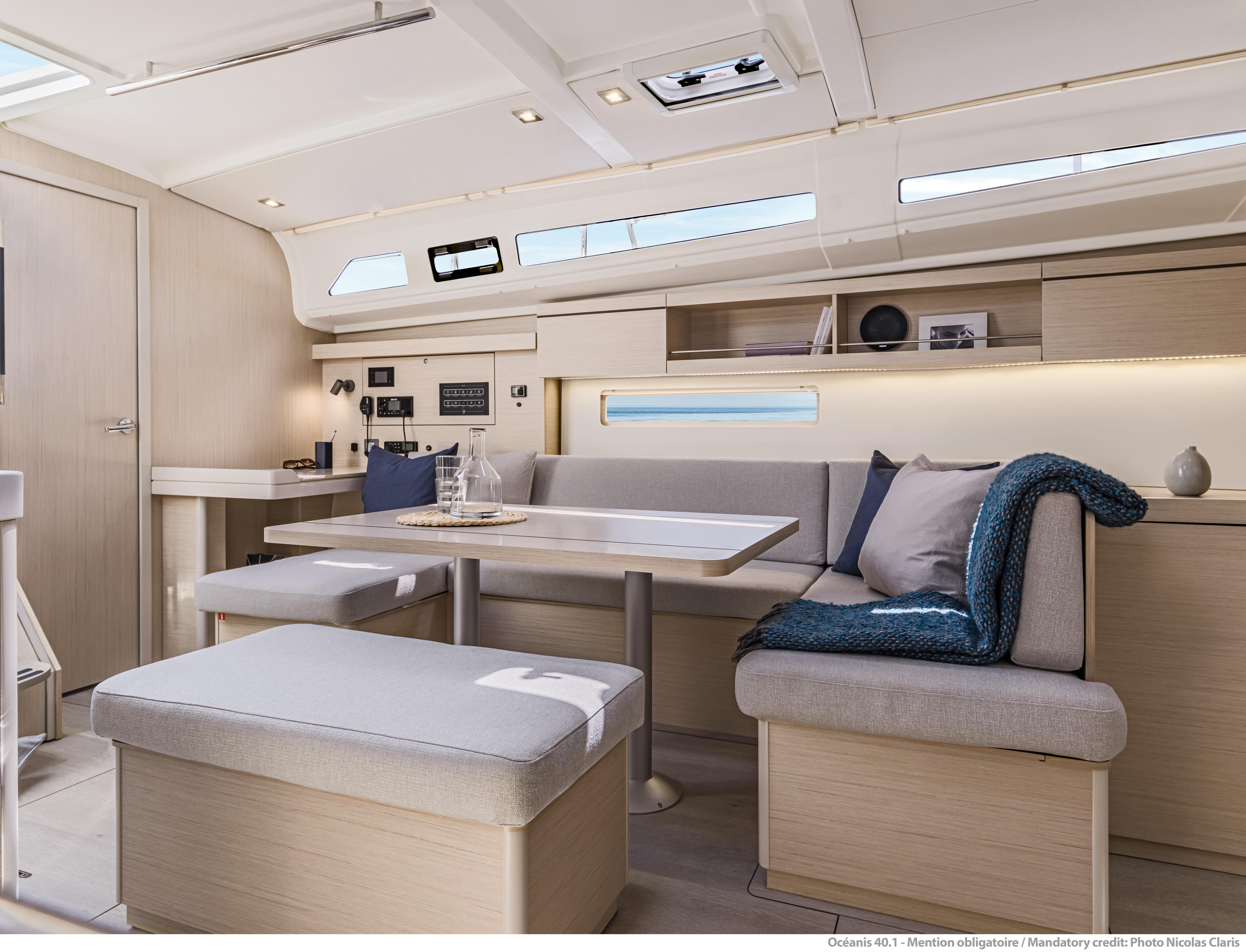 Interior of 2025 Beneteau Oceanis 40.1 yacht, featuring modern seating and dining area.